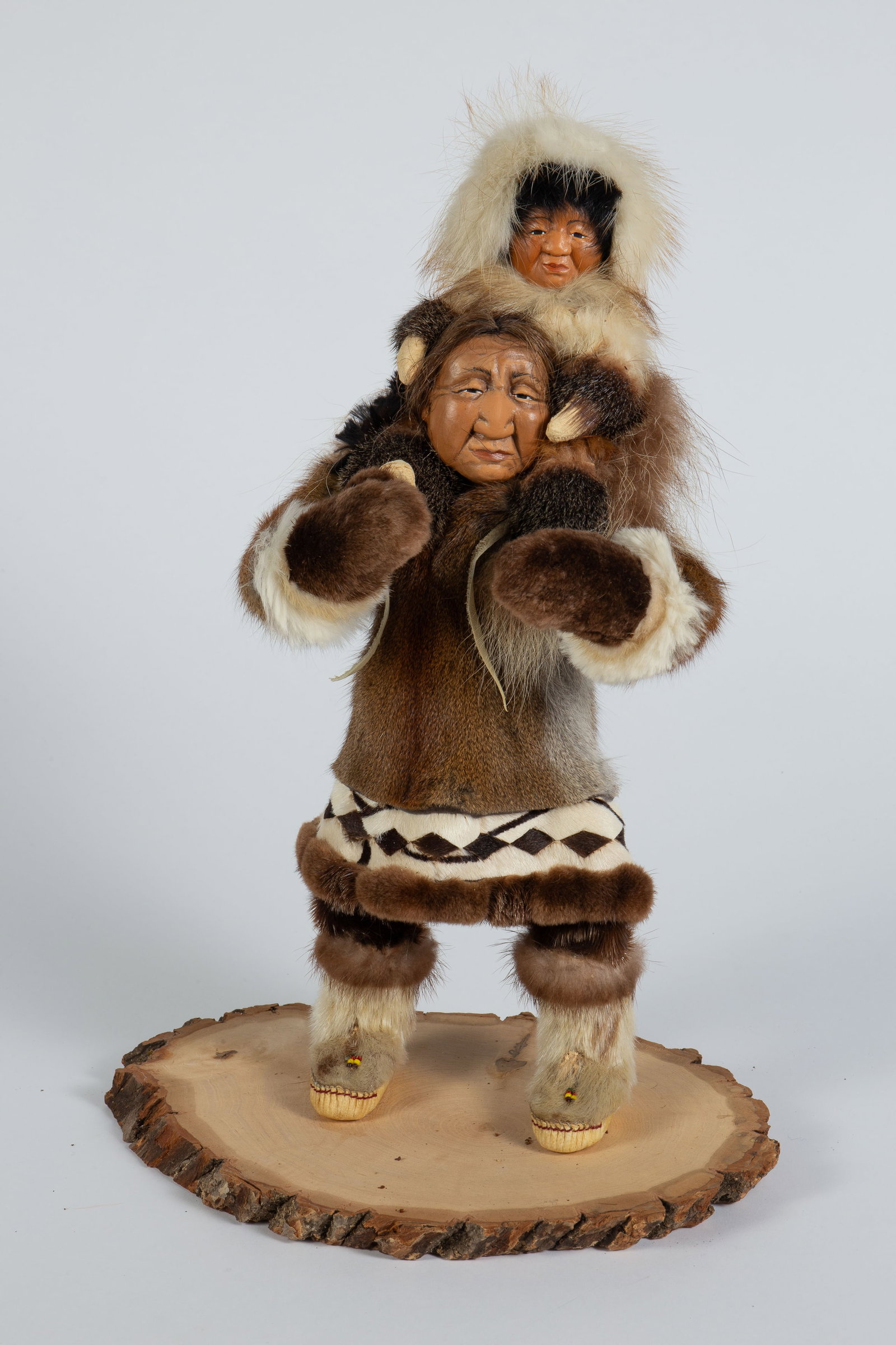 Shona-Hah Lelooska Sculpture of Indians w/ Fur.: It looks to be unsigned. This realistic mixed media piece portrays a woman carrying a small child on her back. Overall, the piece looks to be in nice cosmetic condition. It measures 10 3/4" x 7 3/8" x