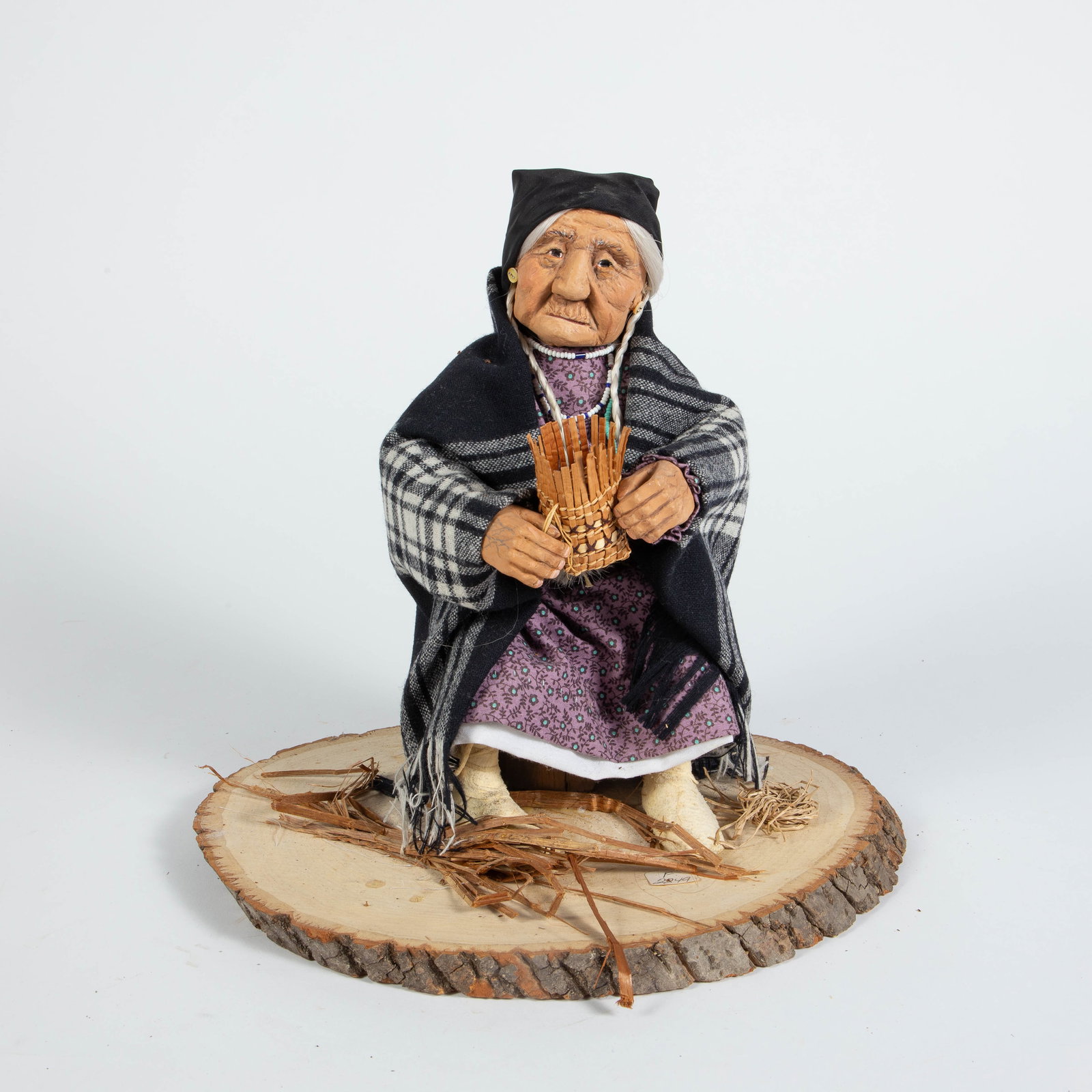 Shona-Hah Lelooska Sculpture- Old Woman w/ Basket.: It is signed underneath. Overall, the piece looks to be in good condition, with a few small stains on the natural wood base. The dimensions are 11 5/8" x 8 7/8" x 11". In-house shipping is available.