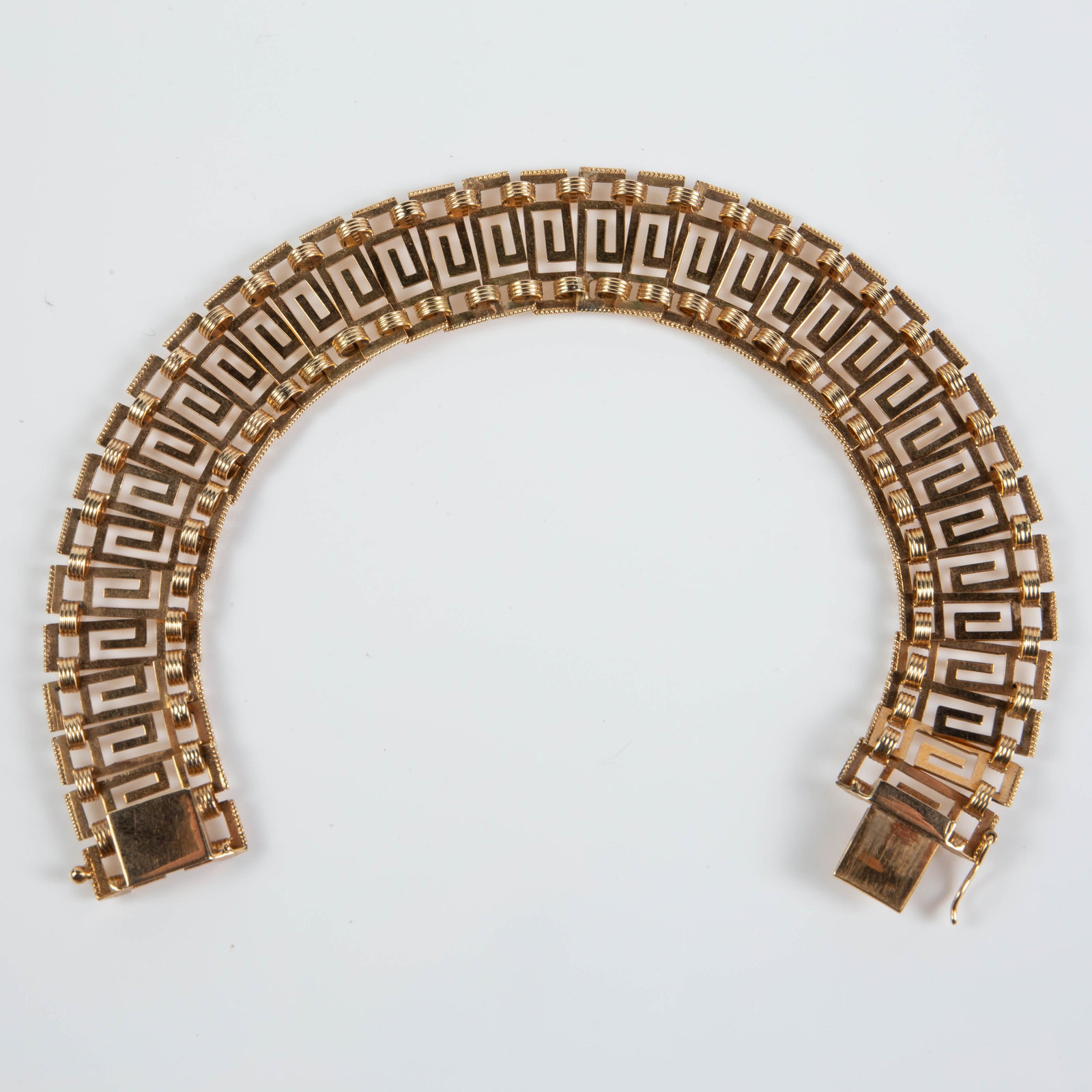 18K Yellow Gold Greek Key Link Bracelet.: The bracelet measures 9" long and 17mm wide. It is marked K18. It weighs 15.4 Pennyweight, or 23.94 Grams. There are a few scratches on the piece. Otherwise, it is in overall good condition. In-house