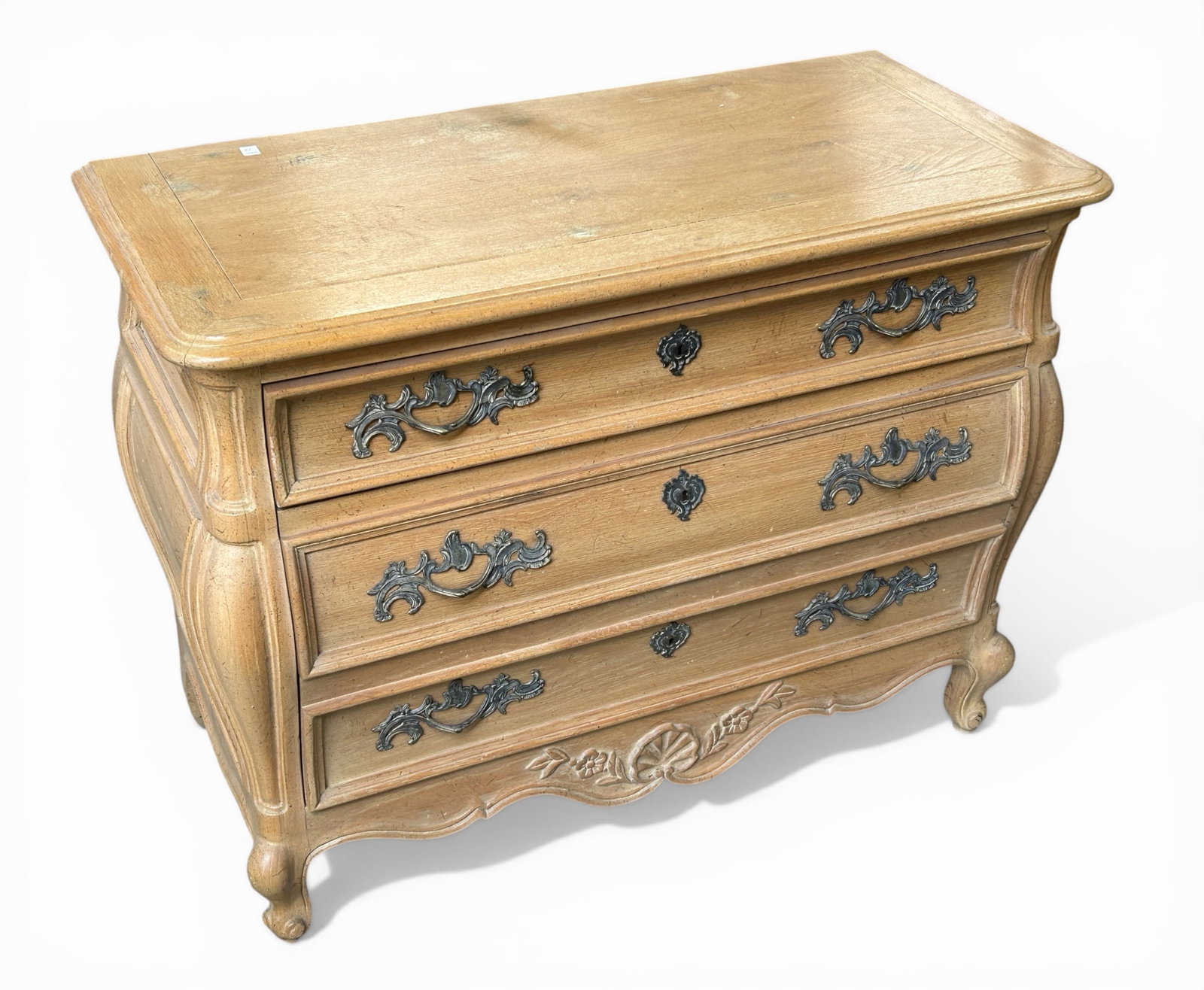 Country French Style Bombe Chest.: The light wood chest has three drawers with brass pulls, and decorative escutcheons. It is in good condition, with minor wear. The chest measures 42" wide, 19 1/2" deep, and 32" tall. Third-party
