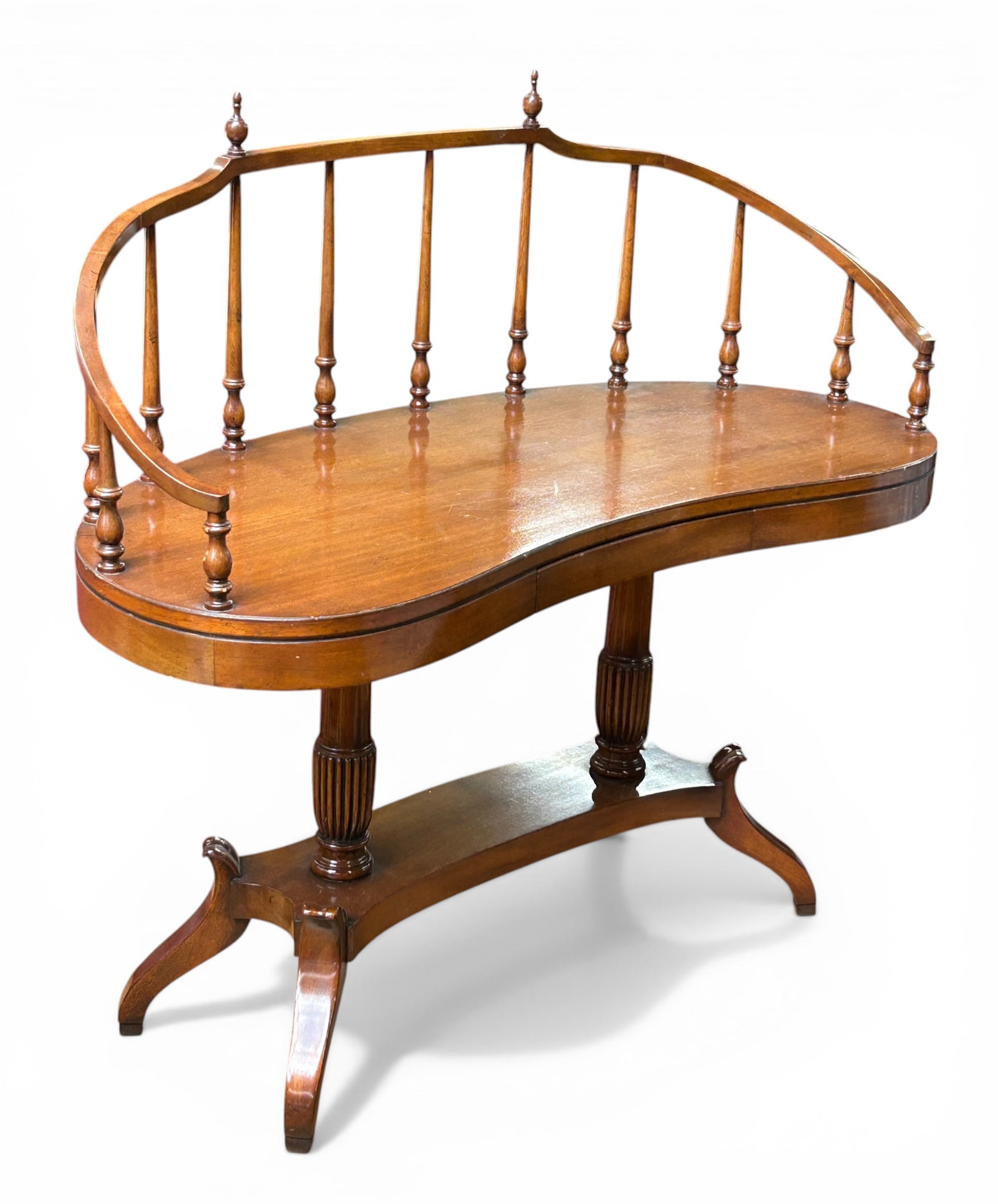 Duncan Phyfe Mahogany Desk or Hall Table.: This piece has a kidney shaped design with spindles and finials, a center drawer, column supports, and curved legs. There is a broken area next to one of the finials, as well as some scratches. It