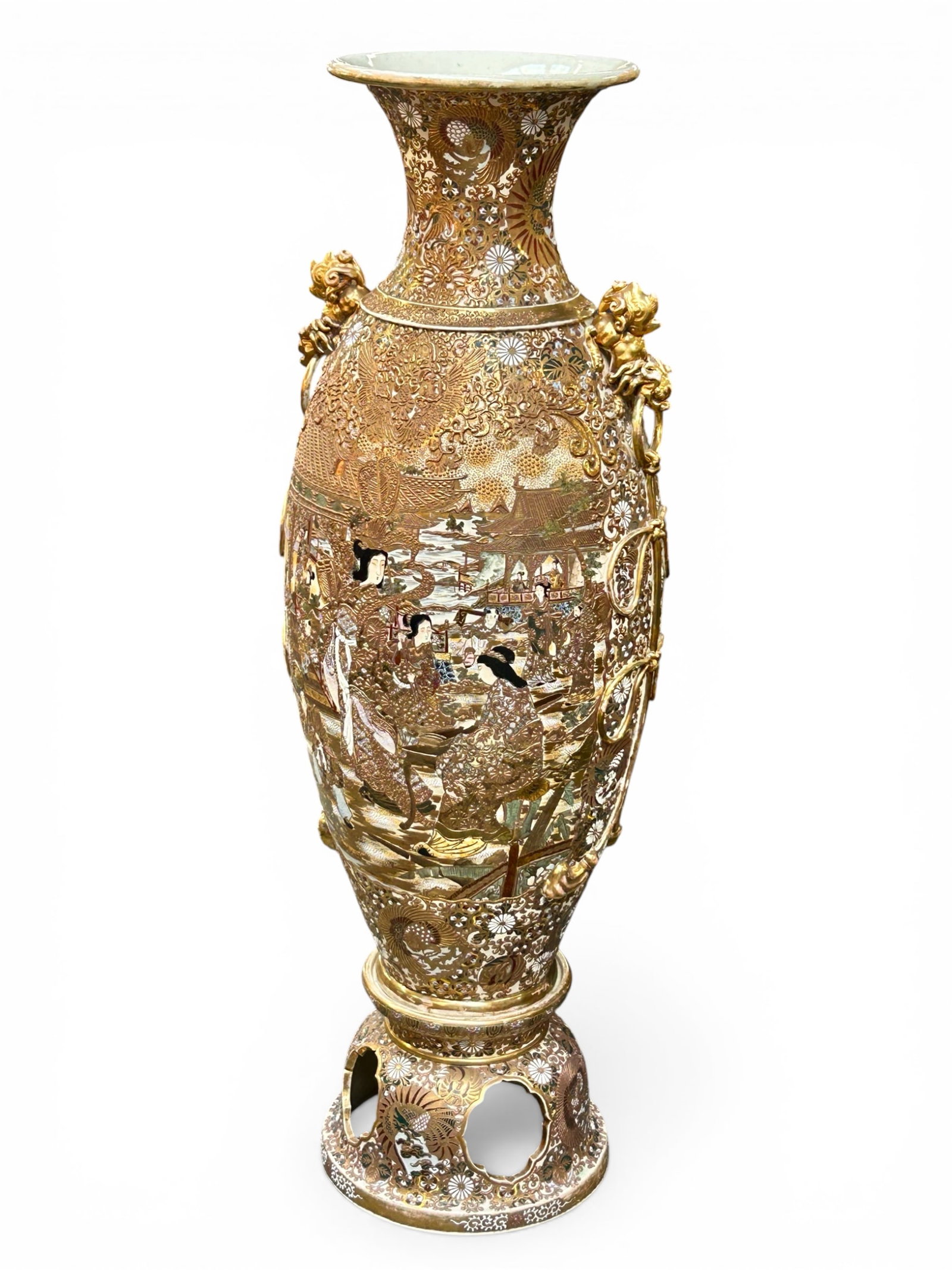5 Foot Japanese Satsuma Porcelain Vase w/ Stand.: This massive palace size vase is adorned with figures of Japanese women, flowers and phoenixes, as well as a pair of gilded foo dog handles. It looks to be in good overall condition, with some wear to