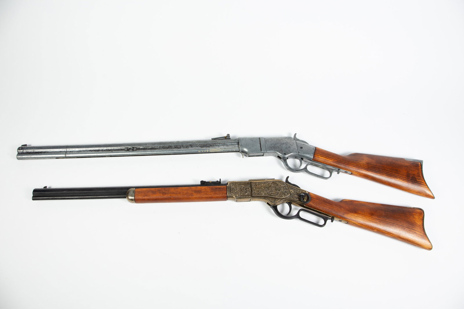 Lot of 2 Stage Replica Rifles.: These are for decoration only; they are made to resemble a lever action rifle. One bears an image of a hunting scene; the other has no decoration. Overall, they look to be in good cosmetic condition.