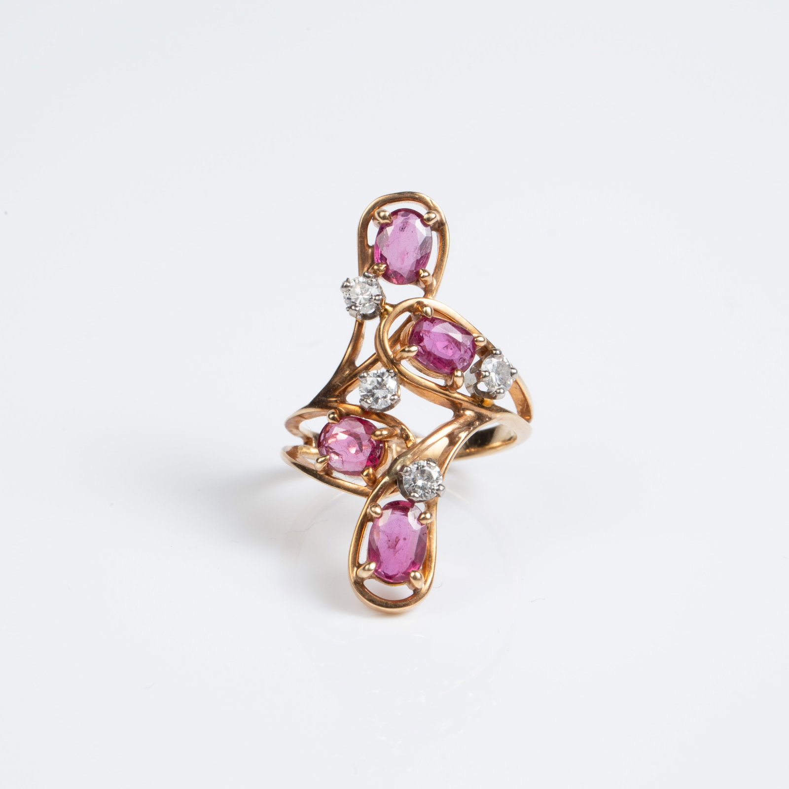 Vintage 14K Gold Ring w/ Diamonds & Rubies.: The ring is marked with what appears to look like a 5 inside a shield shape. It tested appropriately for 14K gold. It features an elongated design with scattered round brilliant diamonds and oval cut 