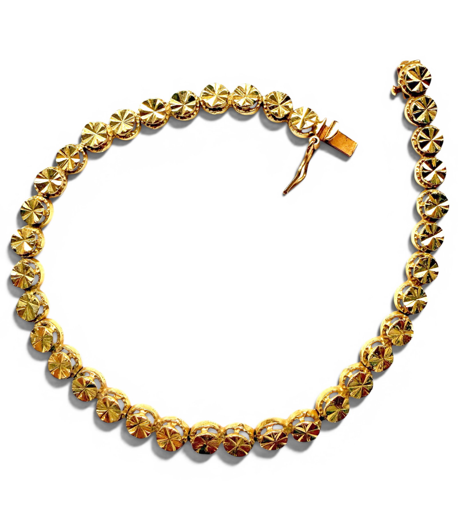 14K Yellow Gold Sunburst Disk Tennis Bracelet: The lot consists of a 14K yellow gold tennis bracelet with round sunburst cut links. It is marked 14K, along with a maker's mark on the clasp. It measures 7 3/8" long and 5mm wide. It weighs 5 Pennywe
