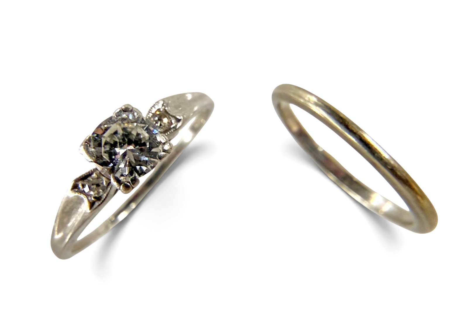 14K Platinum Diamond Engagement Ring & 14K Band.: The lot consists of two rings. There is a platinum ring with a 5 1/2mm round diamond in a square setting with two flanking round diamonds. It is marked Platinum, along with a partial maker's mark that