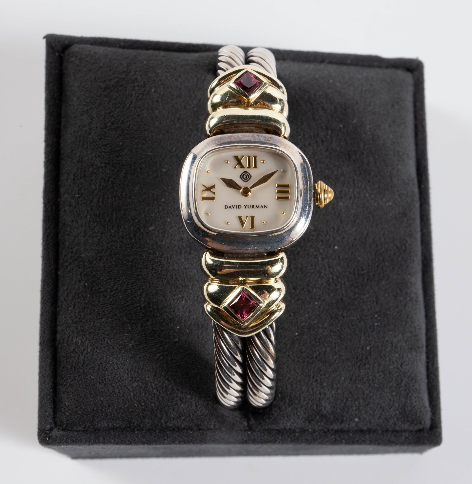 David Yurman Sterling & 14K Gold Jeweled Watch.: The cuff bracelet watch is marked David Yurman 925 585 on the back of the case and on the clasp. It is model number T-51875. It has two square cut pink rhodolite garnet stones and a mother of pearl di
