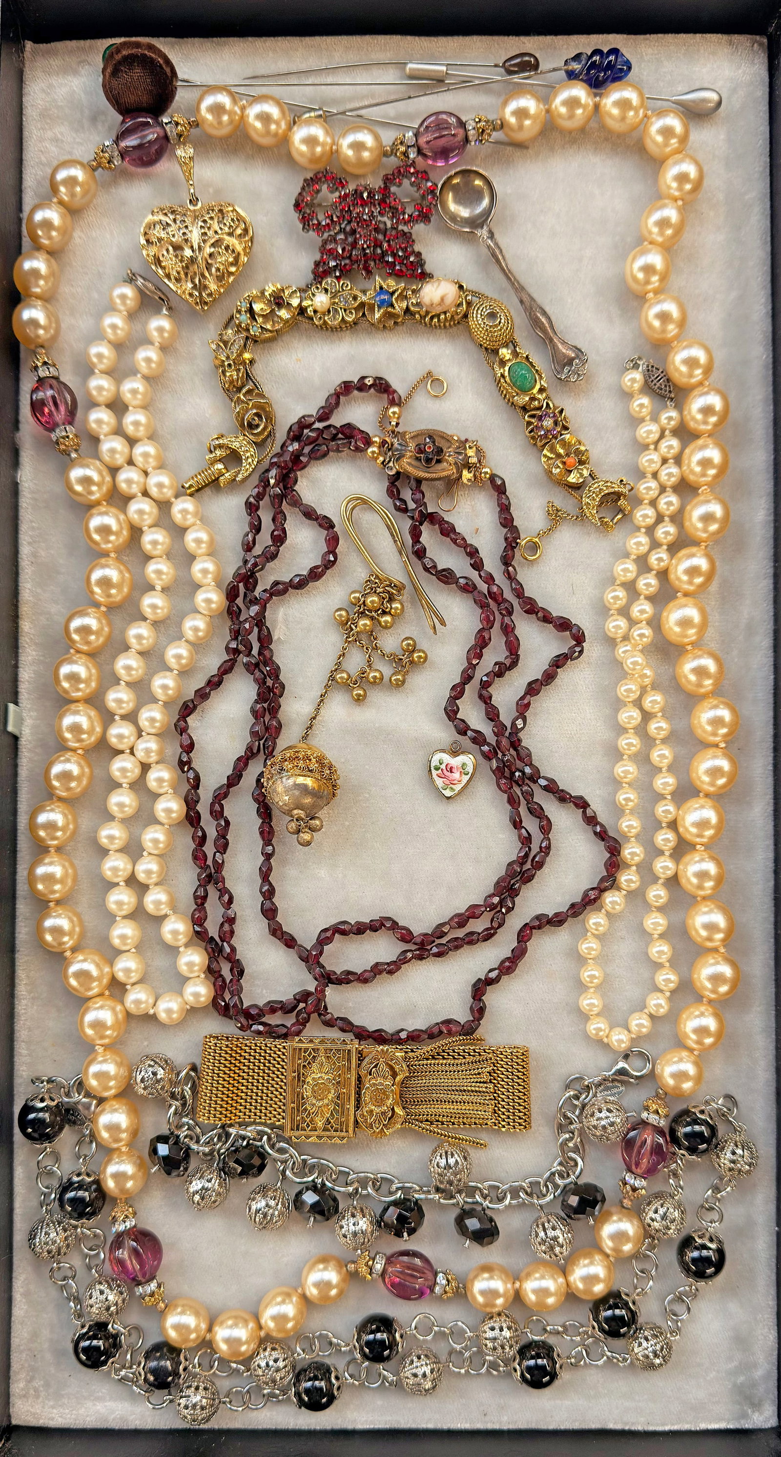 Lot: Jewelry - Antique Garnet, Sterling Spoon, Etc: The lot contains 18 pieces of jewelry. There are a couple of antique pieces with garnet stones. There is a 3-strand necklace with an ornate clasp, and a brooch which may have been a butterfly, but has