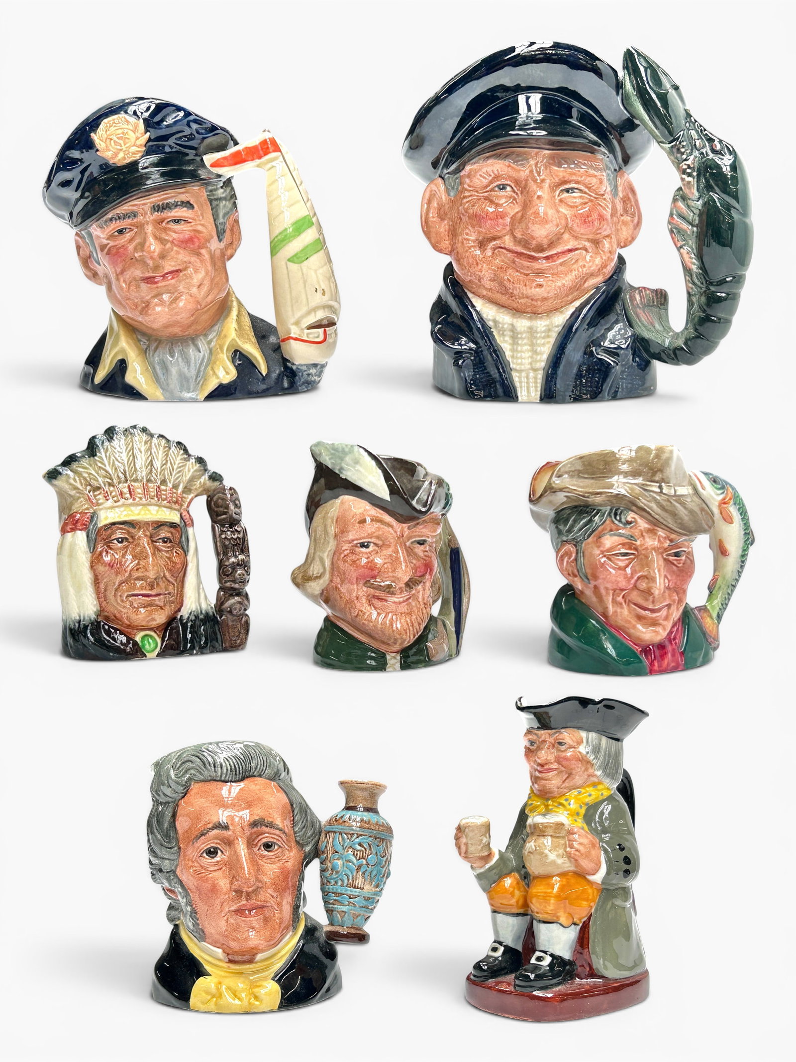Lot of 7 Royal Doulton Toby Jugs.: The lot looks to be in nice condition overall. The largest mug measures 7 1/8" x 5 1/8" x 8". The smallest mug measures 3 5/8" x 3 1/4" x 4 1/8". In-house shipping is available. Please see our