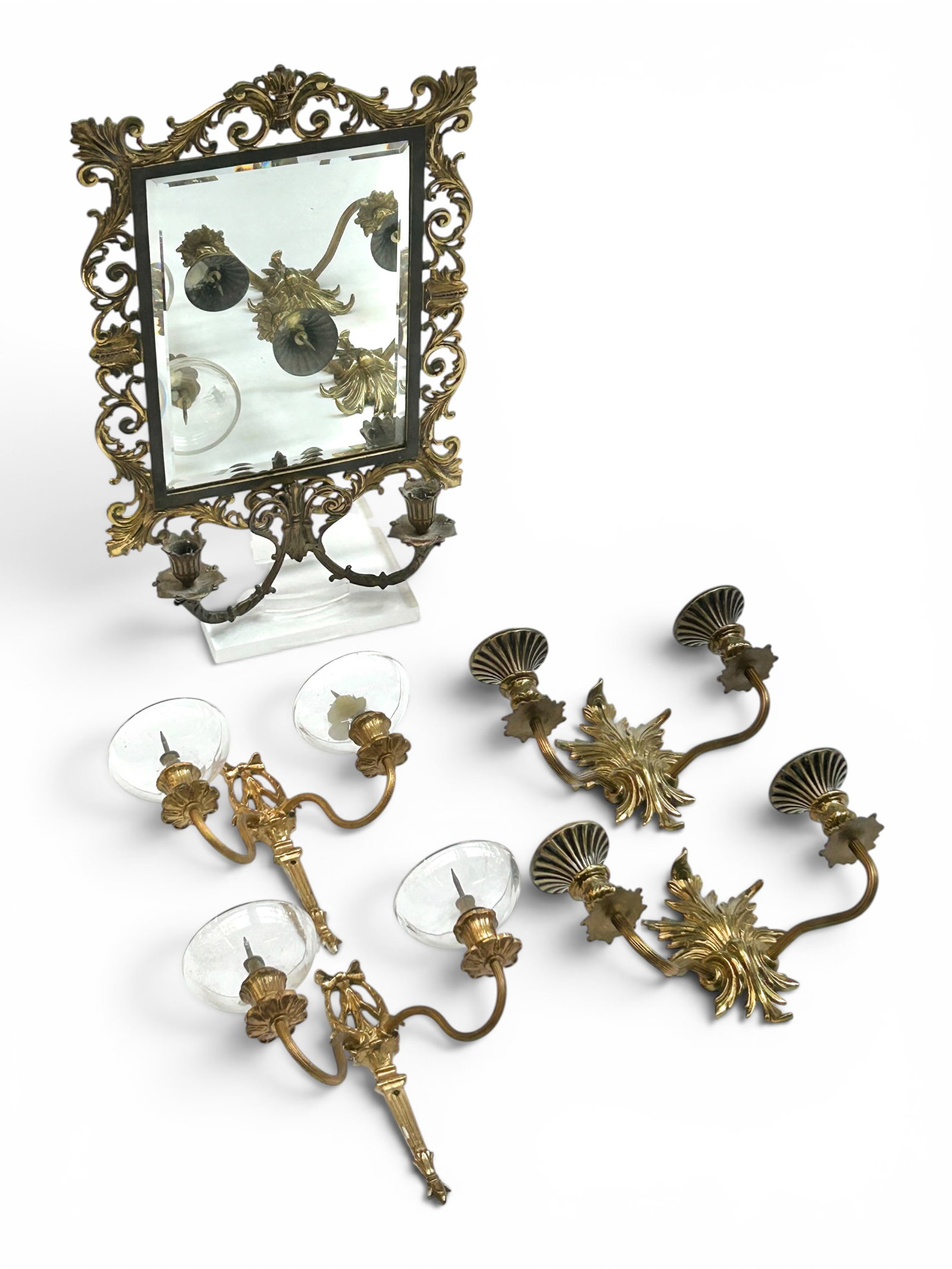 Lot: Gilded Cast Iron Sconce Mirror & 4 Sconces.: The lot contains 5 items. There is a gilded cast iron bevelled mirror with two candleholders. It is branded B&H 1937 for Bradley and Hubbard. Some of the gilding on this piece has worn off. It measure