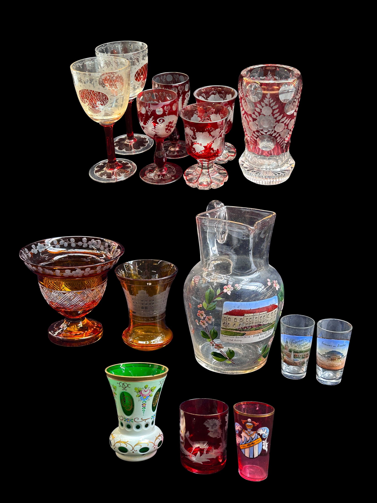 Lot: Antique Glassware - Cranberry, Amber, Painted: The lot contains 15 glass items. They are either handpainted, etched, or cut. There is a pitcher from Hotel Astra in Baile Felix Romania, a couple of German shot glasses, a Fritz Heckert style tumbler