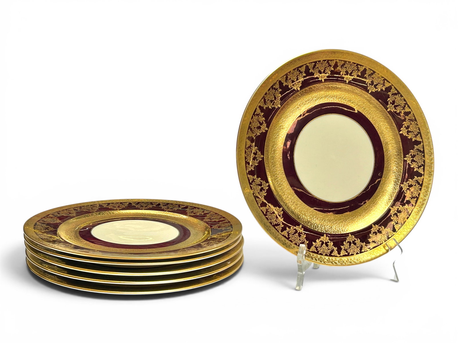 Bavarian Stouffer China Gilded Dinner Plates.: It is a set of 6 plates, with burgundy and gold borders. Overall, the lot looks to be in good condition, with some scratches. Each plate measures 11" x 11" x 7/8". In-house shipping is available. Plea