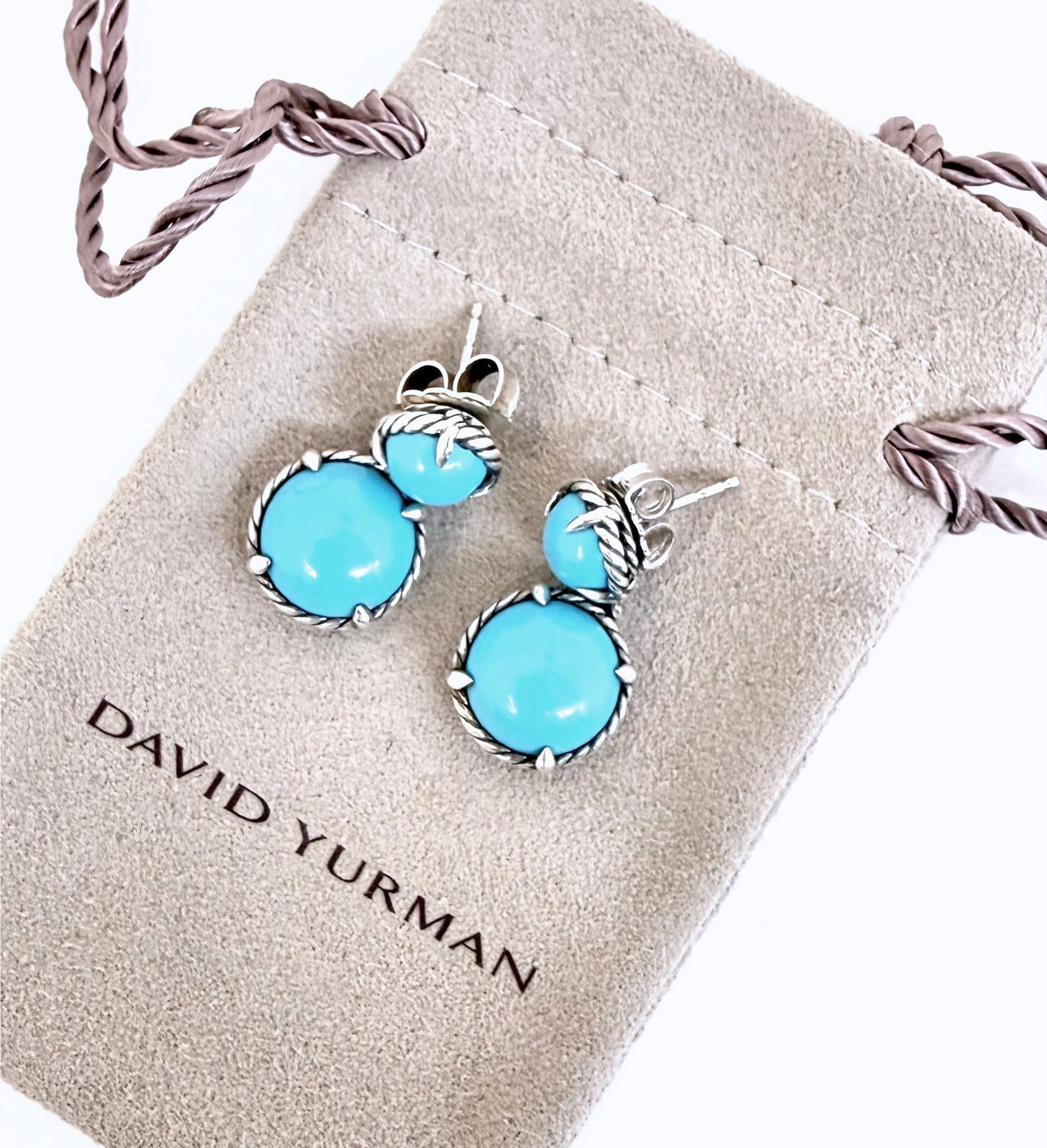 David Yurman Sterling & Turquoise Dangle Earrings.: The earrings are marked D.Y. 925 near the post. They feature 2 sleeping beauty turquoise cabochons in sterling silver settings with rope style borders. They measure 1" long and 9/16" wide. They weigh 