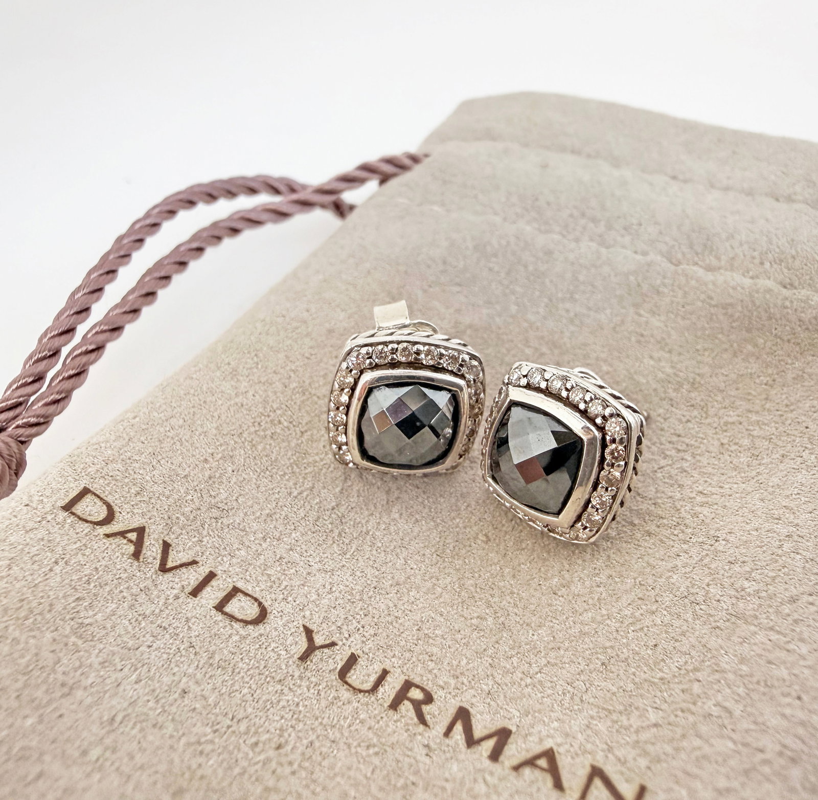 David Yurman Sterling, Diamond, Hematite Earrings.: The Albion earrings feature a sterling silver setting and a multifaceted cushion style hematite stone with a round brilliant diamond border. They are marked M / D.Y. / 925 on back of the earrings. The