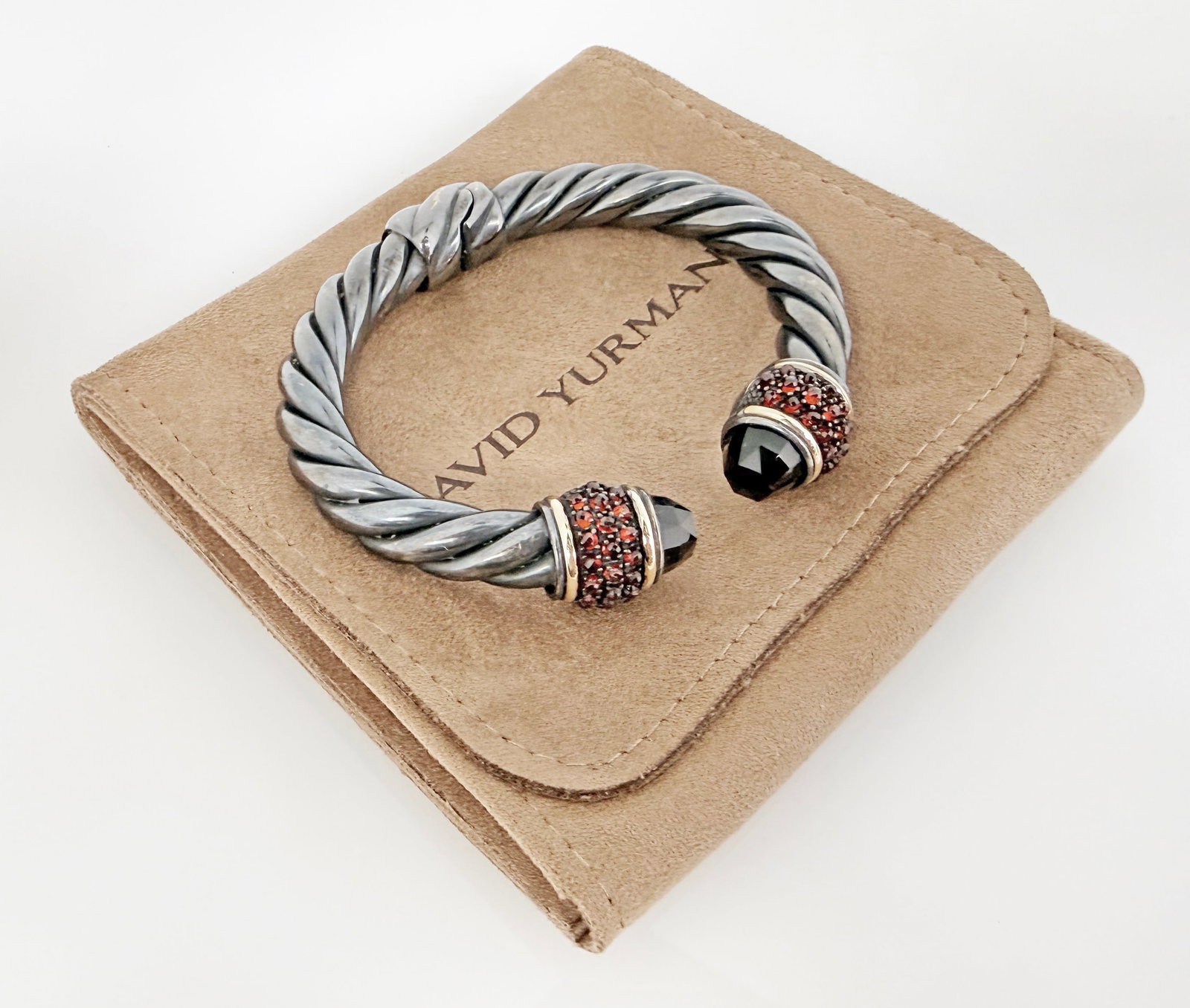 David Yurman Osetra Cable Garnet & Onyx Bracelet.: The Osetra Berries sterling silver cable bracelet features black onyx ends, and clusters of red garnet stones enclosed by a couple of 18K gold bands near the ends. It is marked D.Y. / 925 / 750 near t