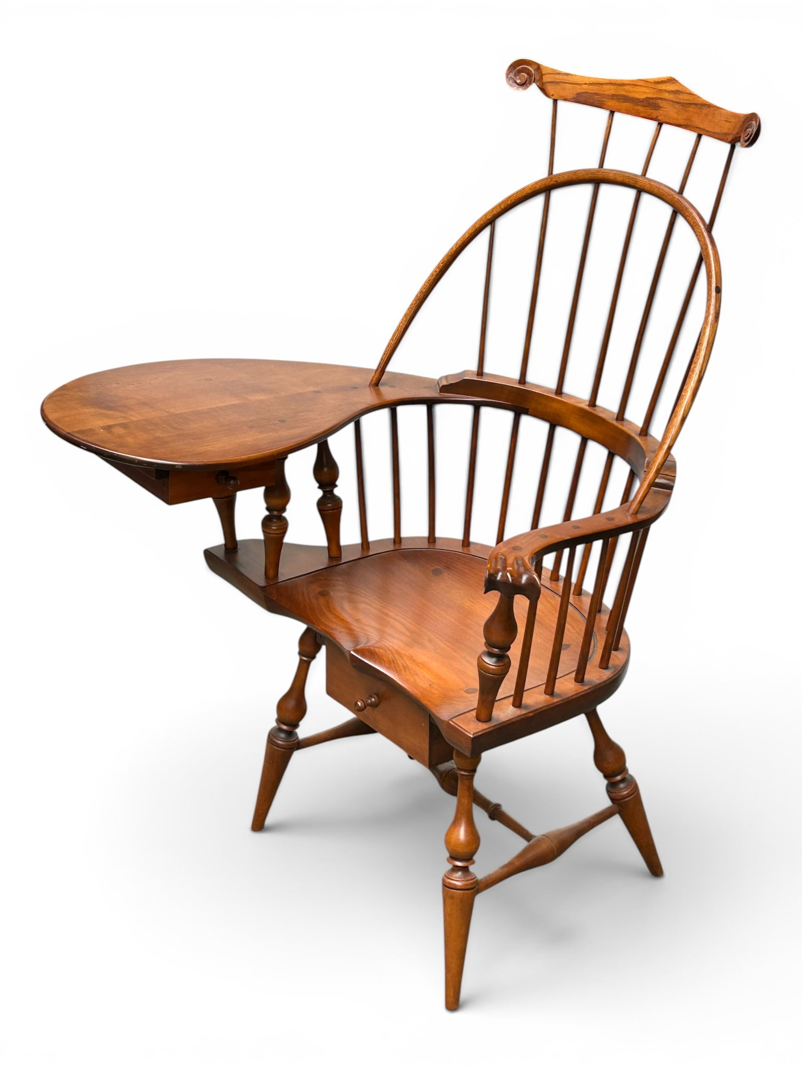D.R. Dimes Double Comb Writing Arm Windsor Chair.: The chair is attributed to D.R. dimes. It has a double comb back, a wide curved writing arm surface with a small drawer underneath, and another drawer under the seat. It has turned wood legs and accen