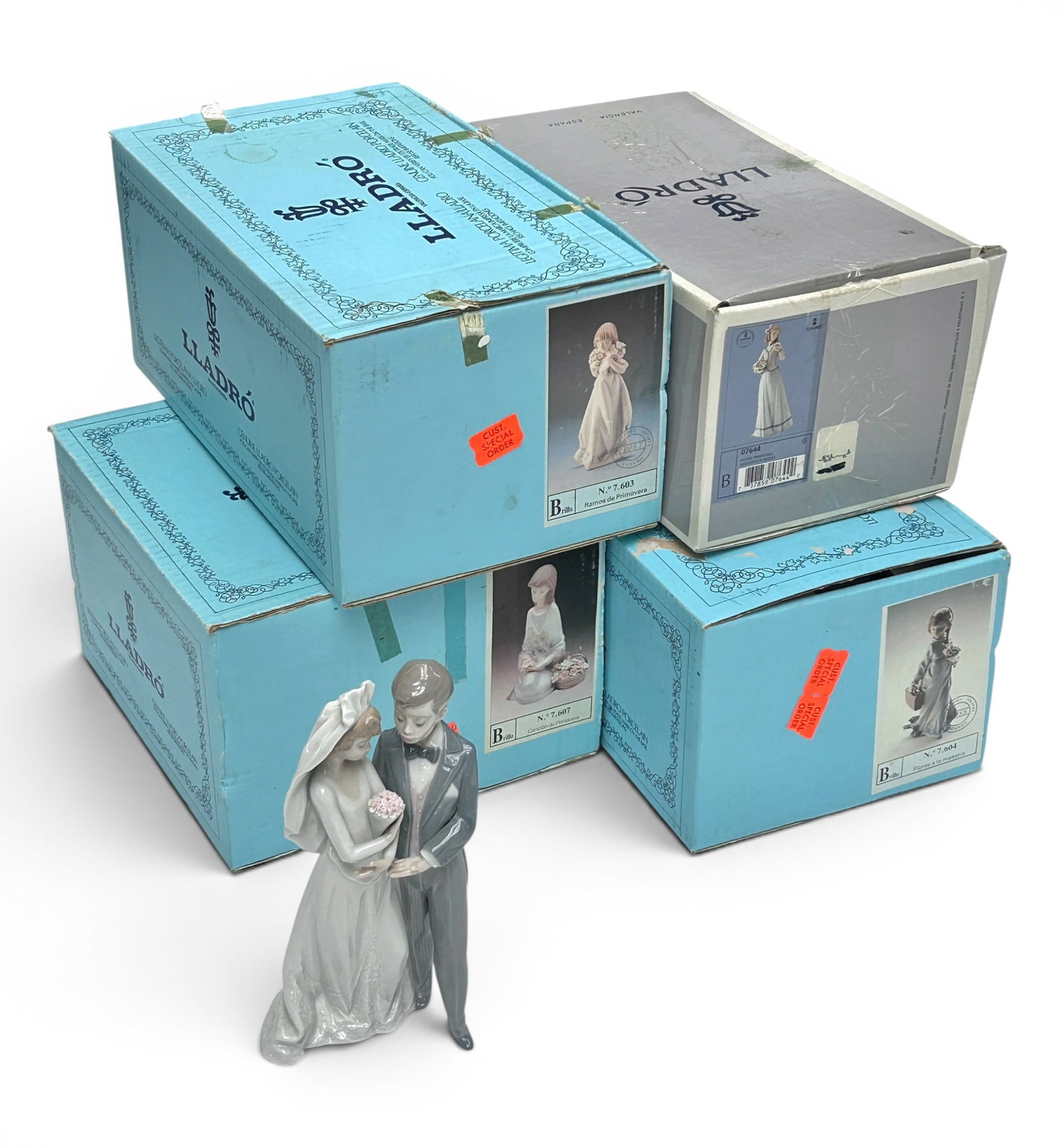 Lot of 5 Lladro Figurines- Girls w/ Flowers.: Four of these figures have the original boxes. Included are "Innocence in Bloom" (small chipped leaf), "Flower Song" (missing a few flowers), "School Days" (some chipped petals), "Spring Bouquets", an