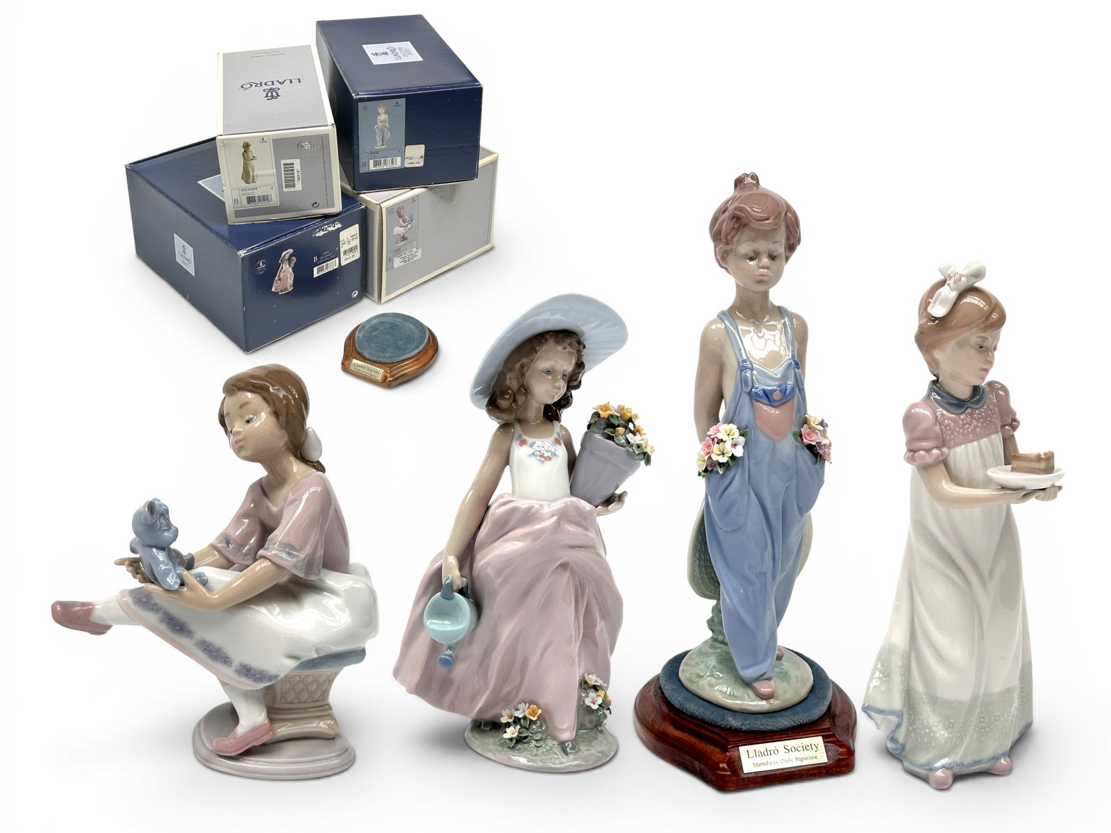 Lot: Lladro Children Figurines w/ Boxes.: Included are two Collectors Society figurines. The lot includes the following items: "Happy Birthday", "Best Friend", "A Wish Come True" (comes with a stand), and "Pocket Full of Wishes". They look to