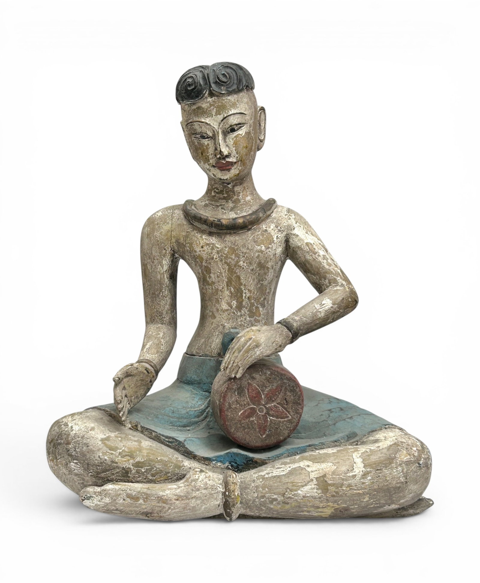 Large Thai Carved Wood Sculpture of a Musician.: The hand carved and painted sculpture depicts a young man playing a drum. It measures 23 3/4" tall, 19 1/4" wide, and 14 1/2" deep. There are some cracks, paint chips, and stains on the piece.