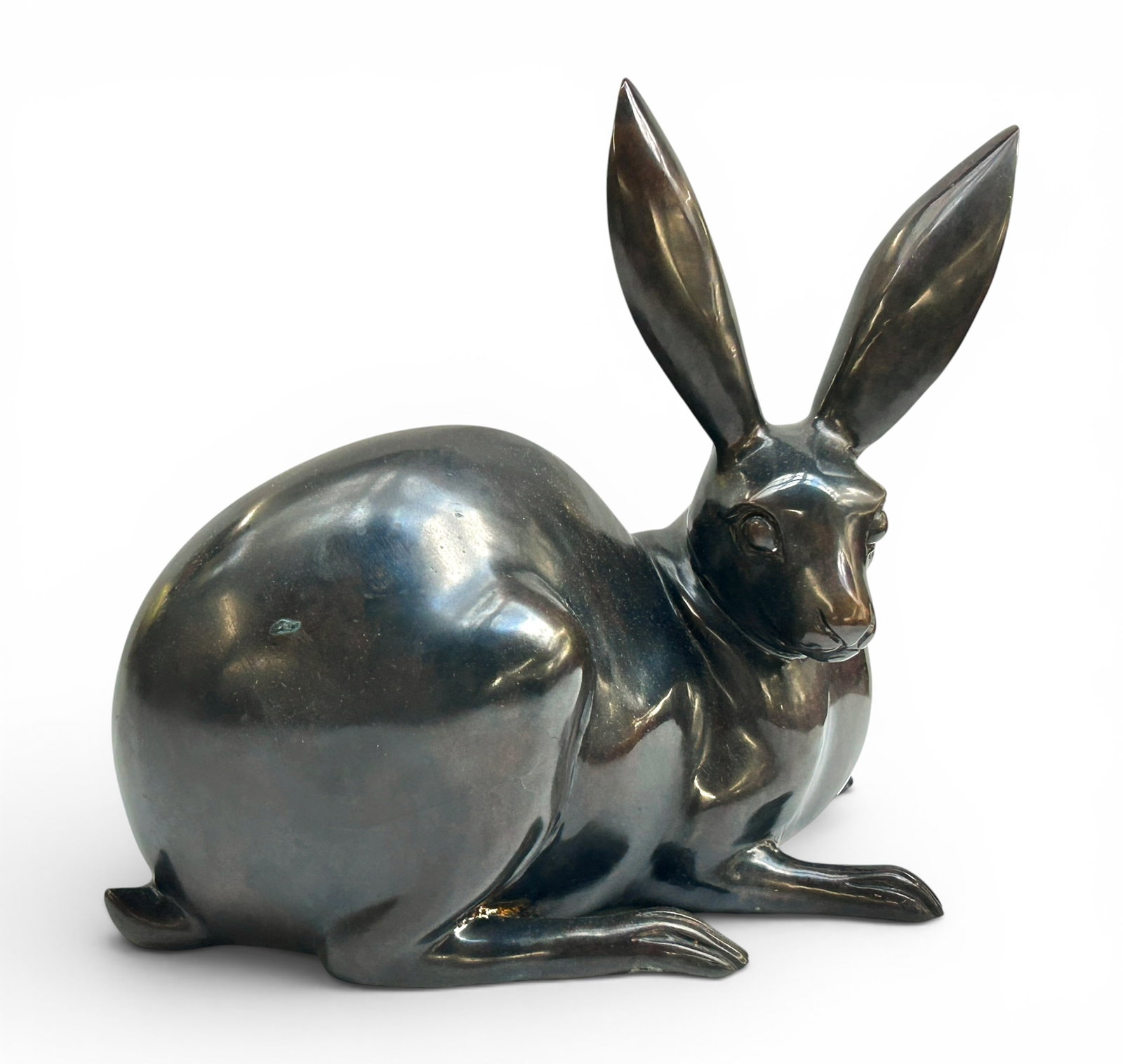 Bronze Rabbit Bunny Sculpture.: The cast bronze sculpture measures 12 1/4" tall, 15 1/4" wide, and 7" deep. There are some scratches and stains on the piece. Otherwise, it is in overall good condition. In-house shipping is available