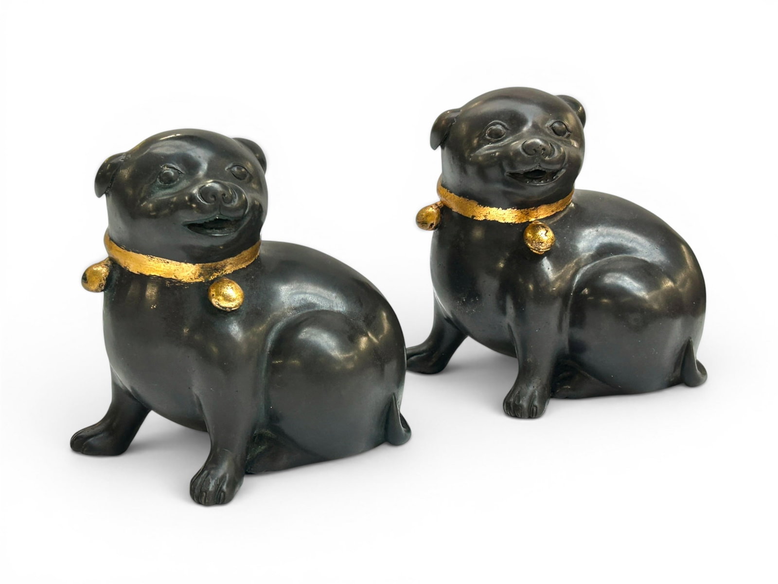 Pair of Signed Bronze Seated Dog Sculptures.: The likely antique petite Taisho style dogs are stamped D.L., and numbered on the undersides out of a series of 5000. Each one measures 6 1/8" tall, 6 1/8" wide, and 4 1/2" deep. There are some
