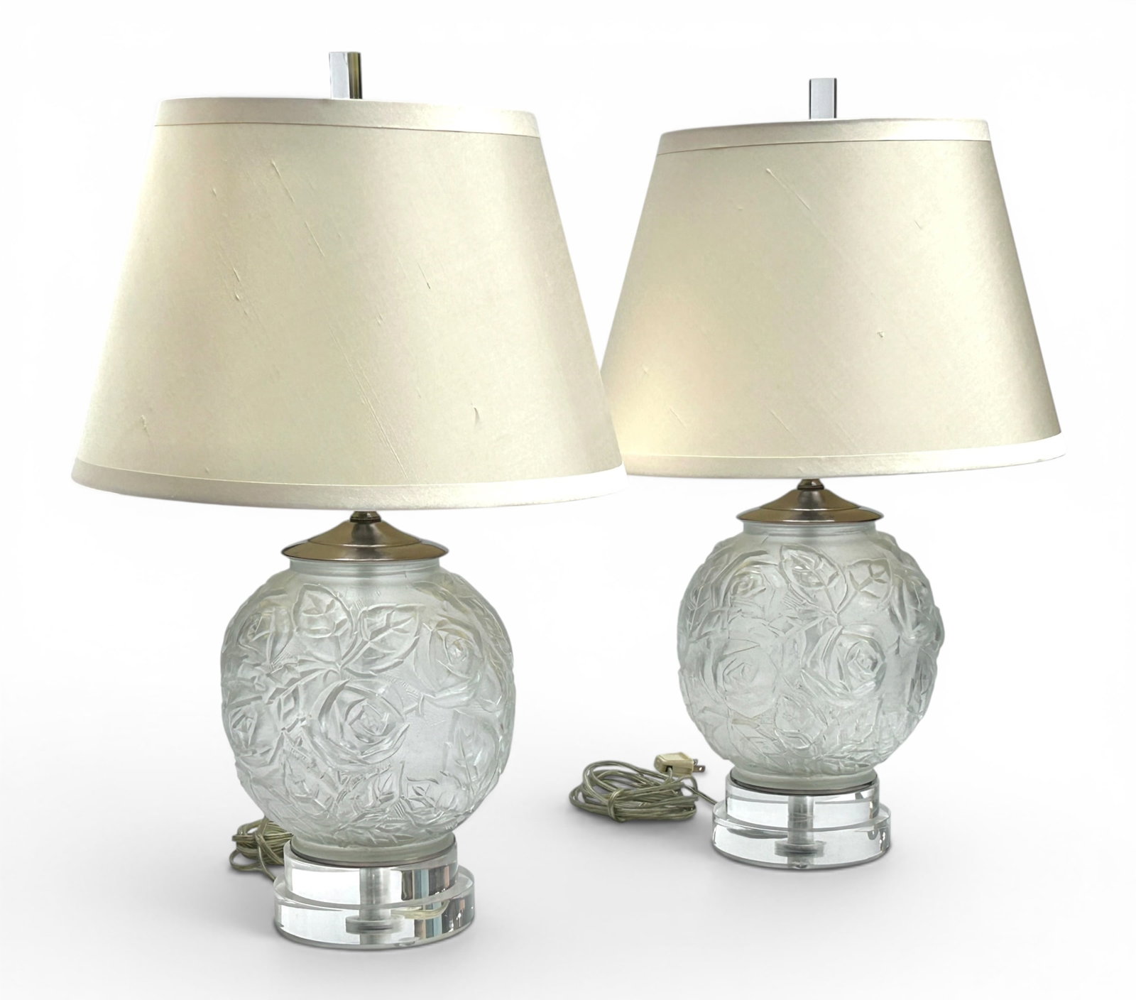 Pr. of Art Deco Style Table Lamps: The lamps feature Joseph Inwald designed round molded glass bases with raised roses and foliage, and a Lucite stand and finial. They are likely by Lang Levin Chicago. Each measures 22" tall, and up