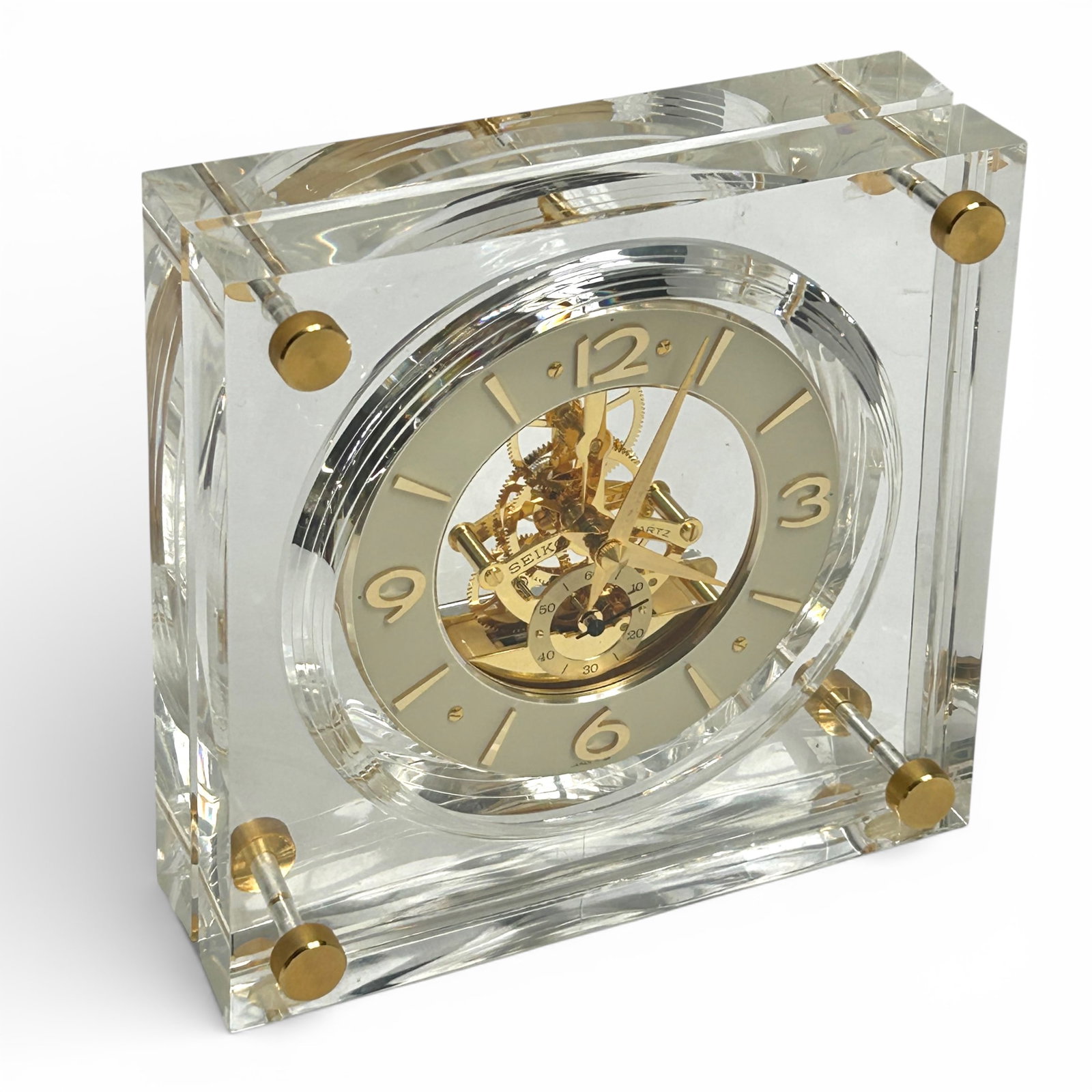 Seiko Quartz Lucite Skeleton Desk Clock.: This beautiful vintage desk clock has a Lucite case with brass fittings, numbers, hour markers, hands, and movement parts. It measures 7" tall, 7" wide, and 2 5/8" deep. It likely needs a new battery,