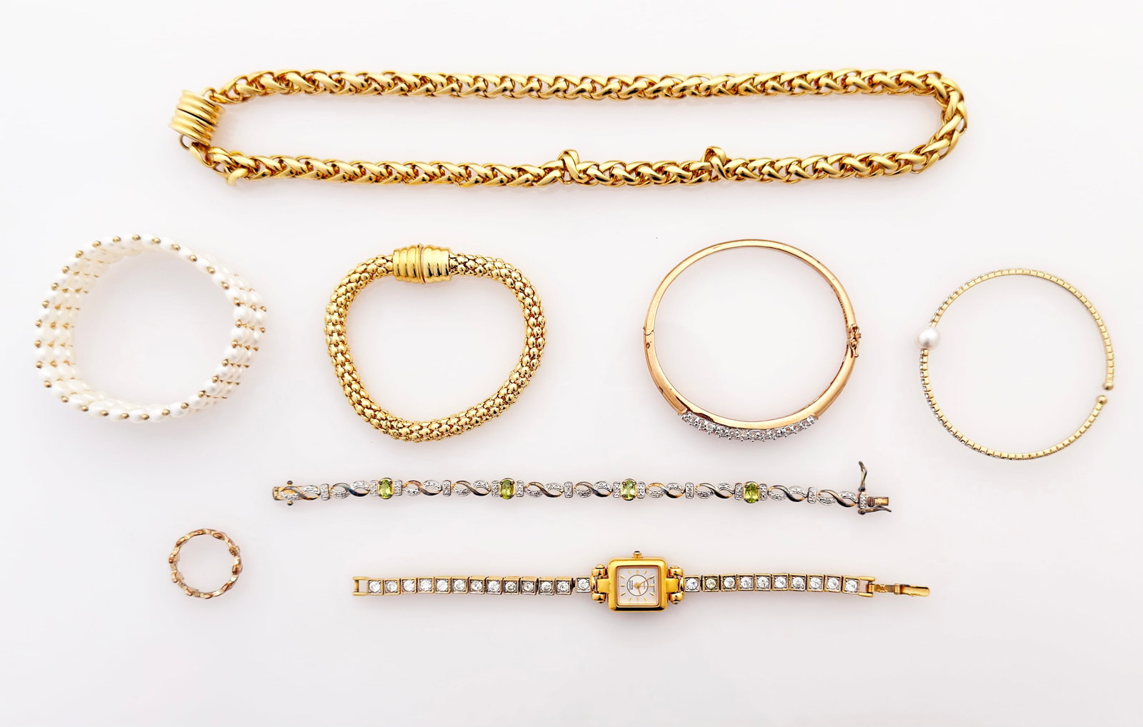 Lot Jewelry - 10K Pearl, Sterling Peridot, Watch.: The lot contains 8 pieces of jewelry. The stand out pieces are a woven 3-strand freshwater pearl bracelet with 10K gold bead spacers, a Carolina Herrera rhinestone watch, and a sterling and peridot br