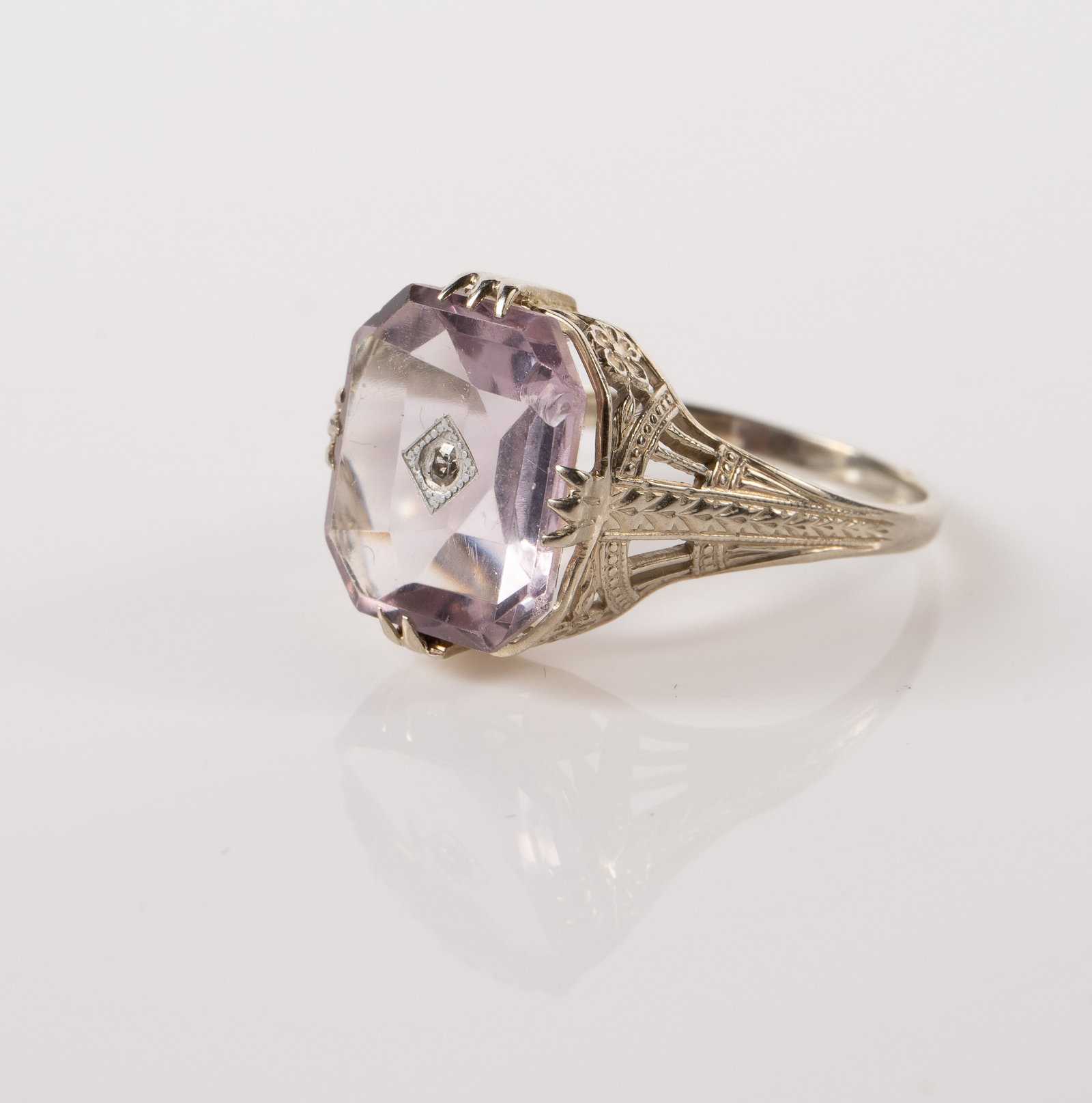 Ostby Barton Antique 14K White Gold Amethyst Ring.: The antique ring is marked OB 14K, along with a maltese cross for Ostby and Barton. The ring features a large baguette cut Rose de France amethyst stone, and a small round moissanite crystal at the ce