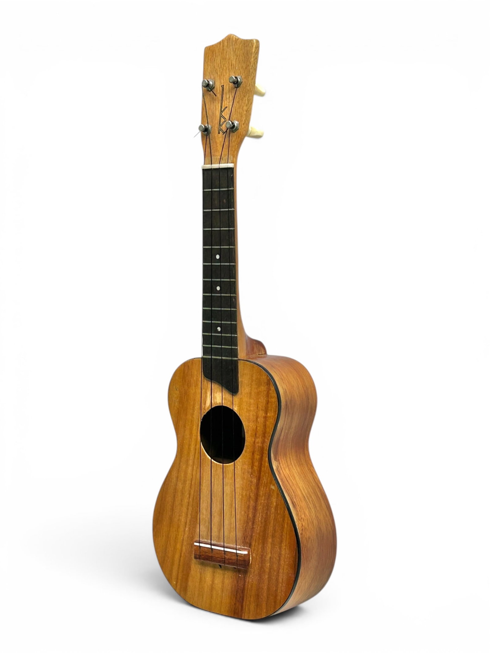 Koa Wood Ukulele, Kamaka, Honolulu Hawaii.: The string instrument is branded on the inside and on the headstock. It measures 21 3/4" long, 6 7/8 wide, and 2 1/2" deep. There is a crack on the back and front of the body. There are also some scra