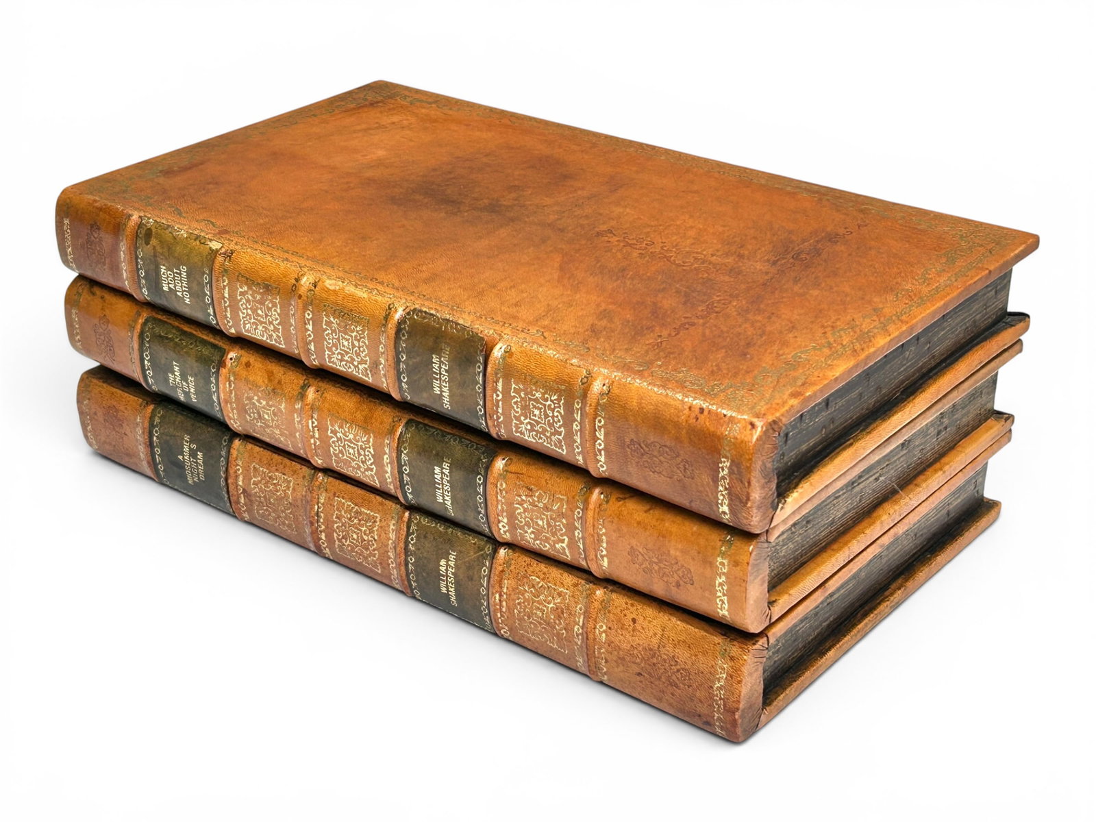 Vintage Shakespeare Faux Book Stack Box.: The vintage secret box depicts a stack of 3 large leather bound Shakespeare plays. The book on top is a flip top lid. The piece measures 5 1/2" tall, 15 7/8" wide, and 8 7/8" deep. There are a few tea