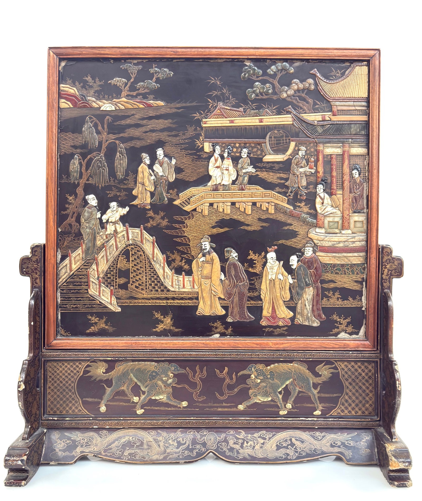 Large Old Chinese Carved Lacquer Table Screen.: The screen has some lacquer loss along the edges and corners. There are some cracks in the lacquer, as well as a bit of stone loss on the bridge scene. The frame also has some losses. Otherwise, the s