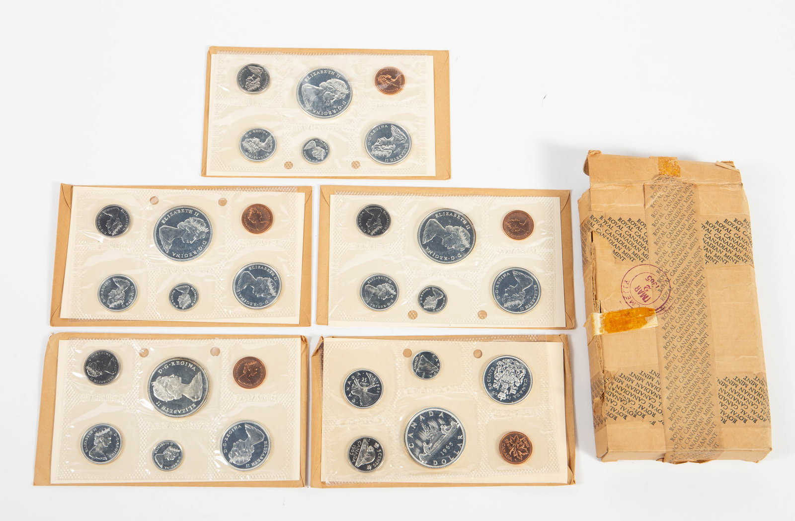 5 Canadian 1965 Proof Sets w/ Original Box.: The proof sets are all in the original cellophane packaging with the original information card, brown envelope, and mailing box. Some of the coins are silver, and a few coins show tarnish. In-house sh