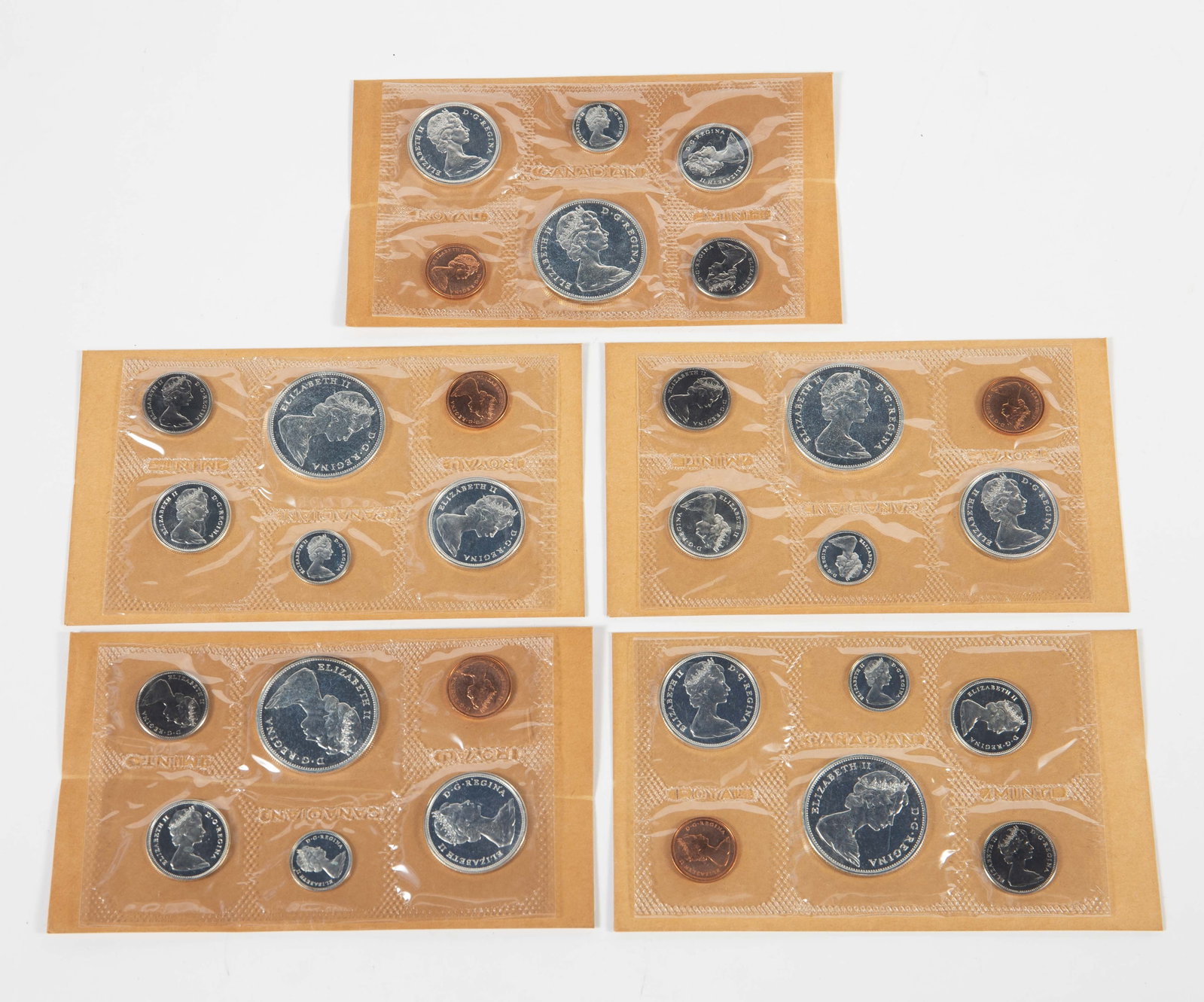 5 Canadian 1965 Proof Sets w/ Original Box.: The proof sets are all in the original cellophane packaging with the original information card, brown envelope, and mailing box. Some of the coins are silver, and a few coins show tarnish. In-house sh
