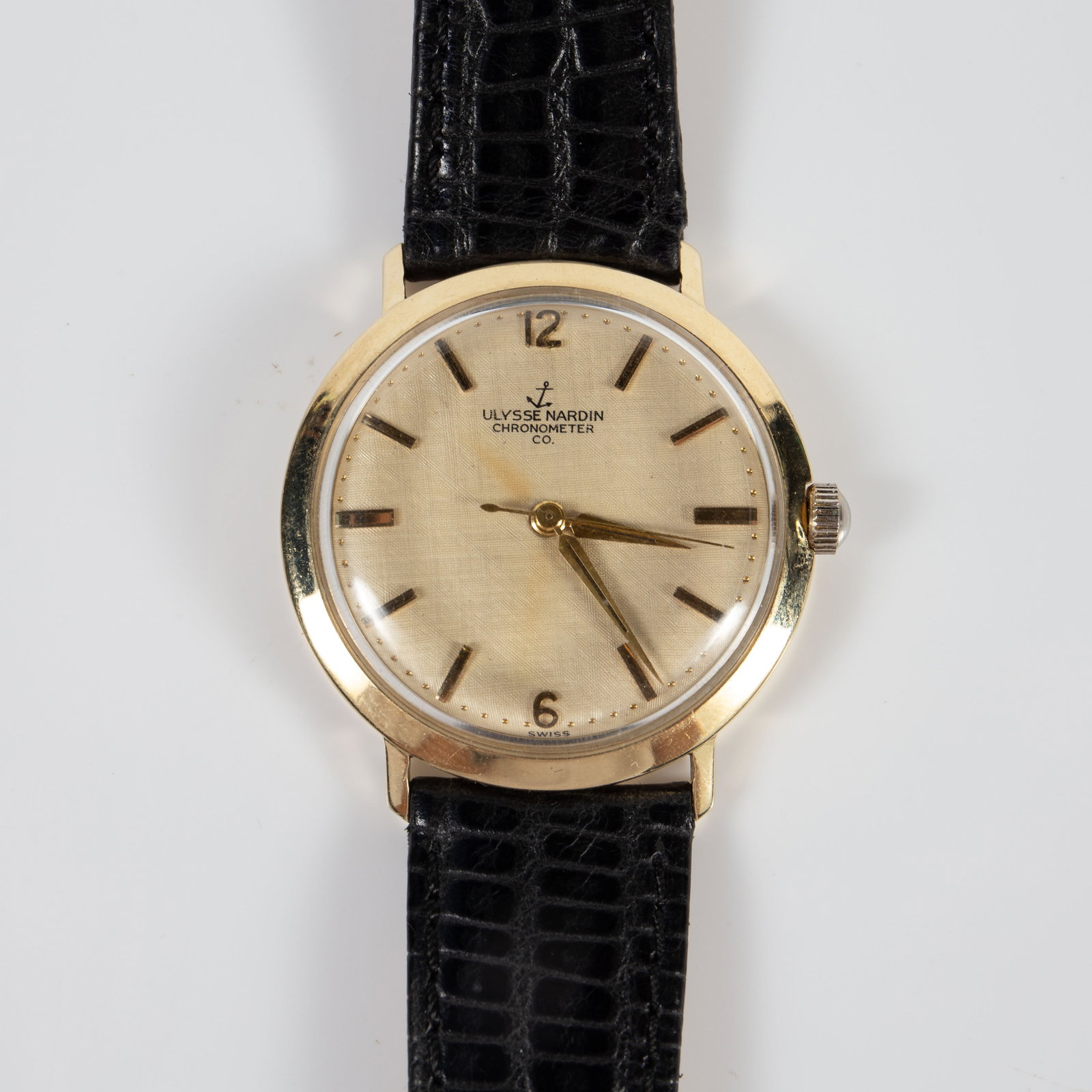 Ulysse Nardin Chronometer 14K Gold Watch.: The watch is marked 14 Karat Gold along with an anchor mark on the back. It ticks, but has not been checked for accuracy. The gold case measures 33mm in diameter, and the black calfskin band is a size