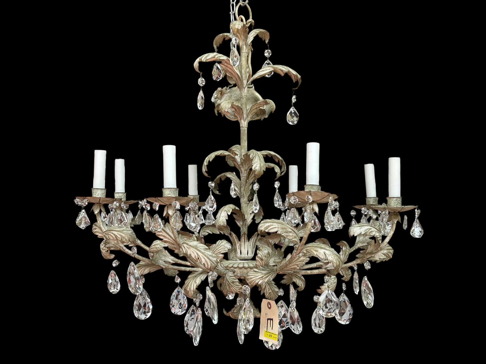 8-Arm Tole Prism Chandelier.: The chandelier is painted white. It features metal leaf decorations and teardrop prisms. It measures 24" long and 28" in diameter (not including the ceiling mount and chain). There are some paint chip