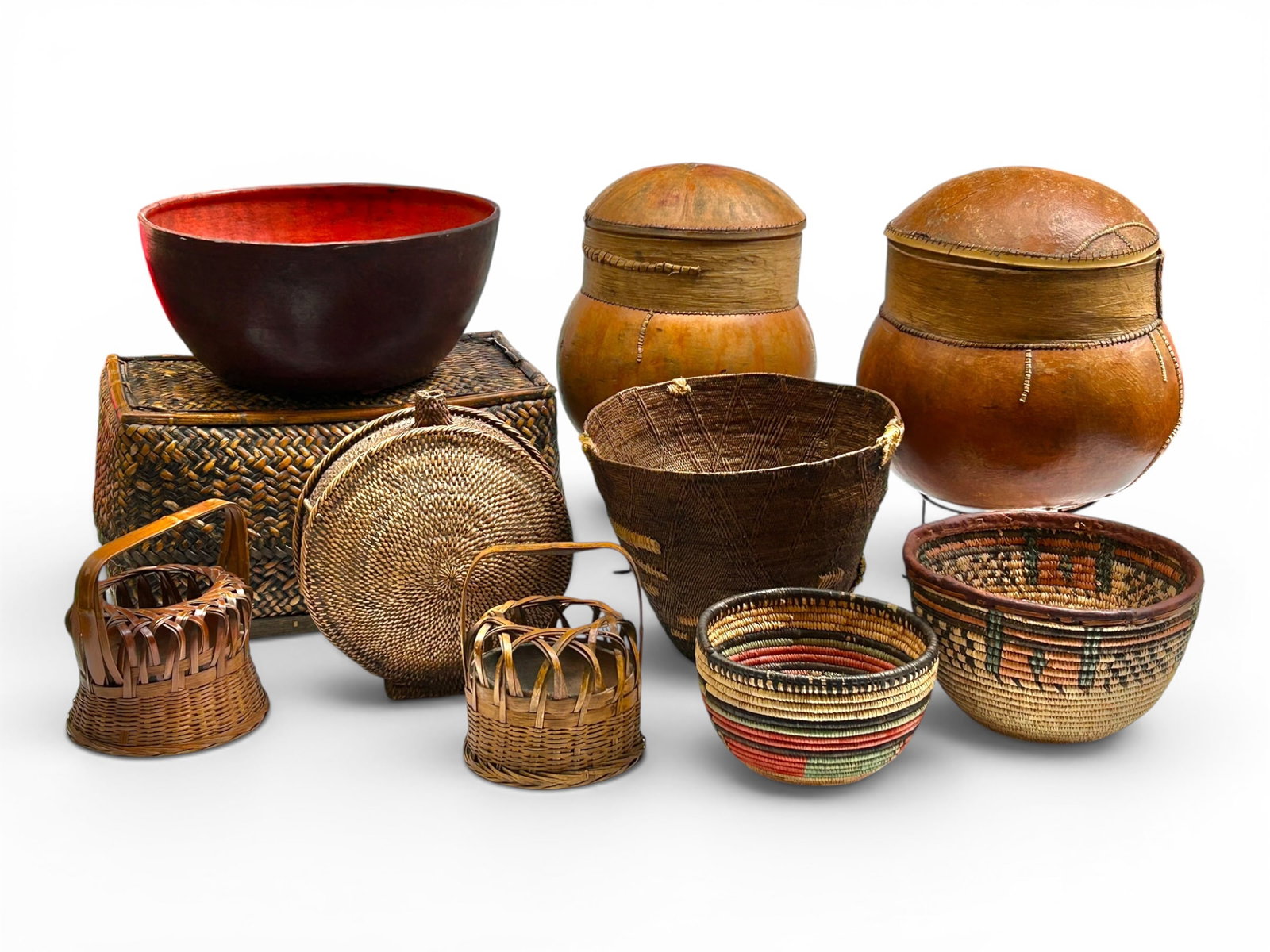 Lot Handmade Baskets & Containers - Gourd, Woven.: The lot contains 10 ethnographic hand made items. Some of the stand out items are a woven bowl with a leather base and rim, a tall woven bin with patchwork which may be original repairs, and 2 large g