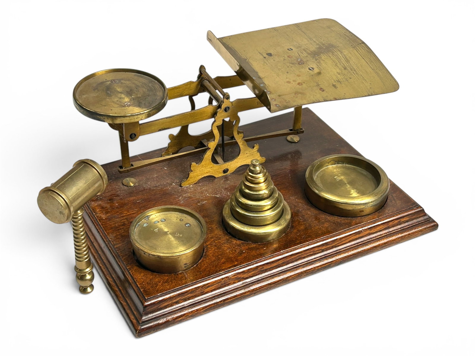 Antique Brass Balance Scale w/ Weights & Gavel.: The lot contains an old brass balance scale on a wooden base. It comes with 10 brass weights from less than 1 Ounce to 4 Pounds. The scale is stamped Warranted Accurate. The lot also contains a heavy 