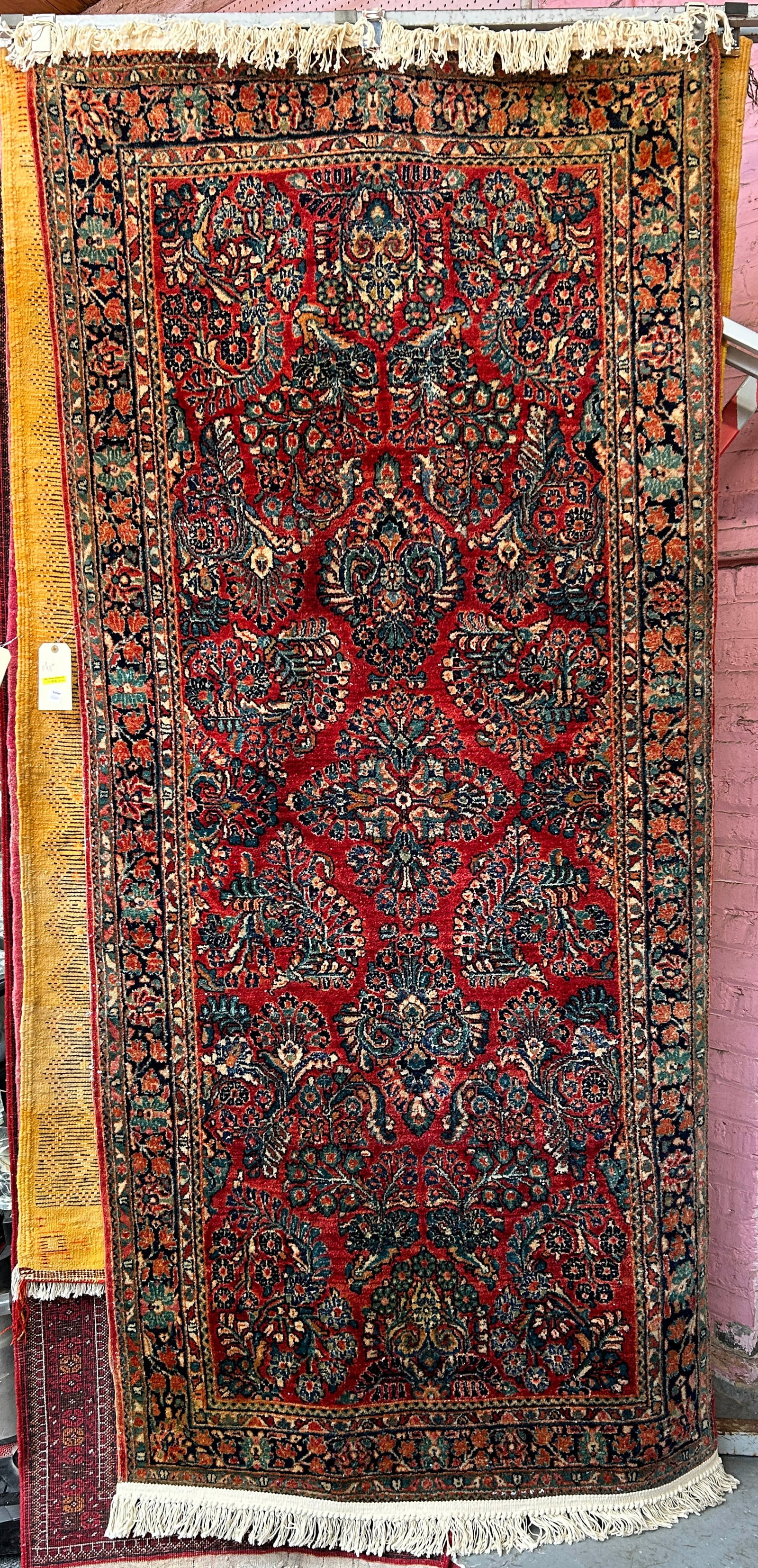 3' 10" x 8' 8" Persian Sarouk Rug.: The rug has some white spots on it, possibly threads. It has a little wear on one edge of the rug. Otherwise, it looks to be in good overall condition. In-House Shipping is available for this rug. Ple