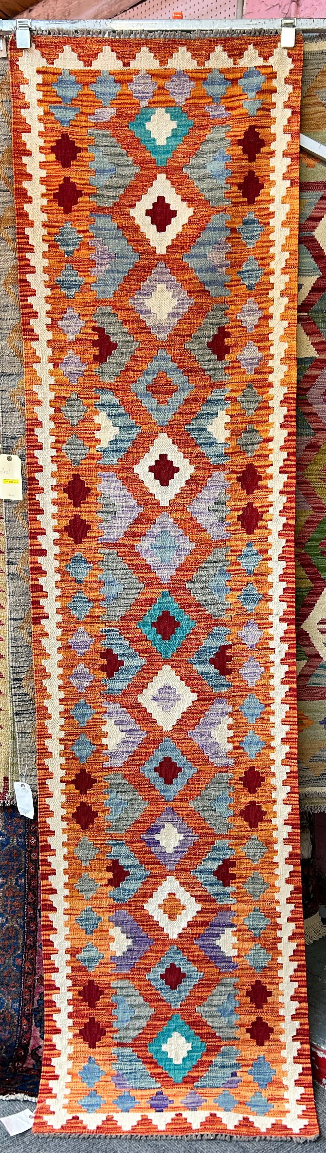 2' 4" x 9' 7" Colorful Kelim Runner Rug.: This rug has vibrant colors, and would likely fit well with any decor. It is in good condition. In-House Shipping is available for this rug. Please see our website for our in-house shipping procedures