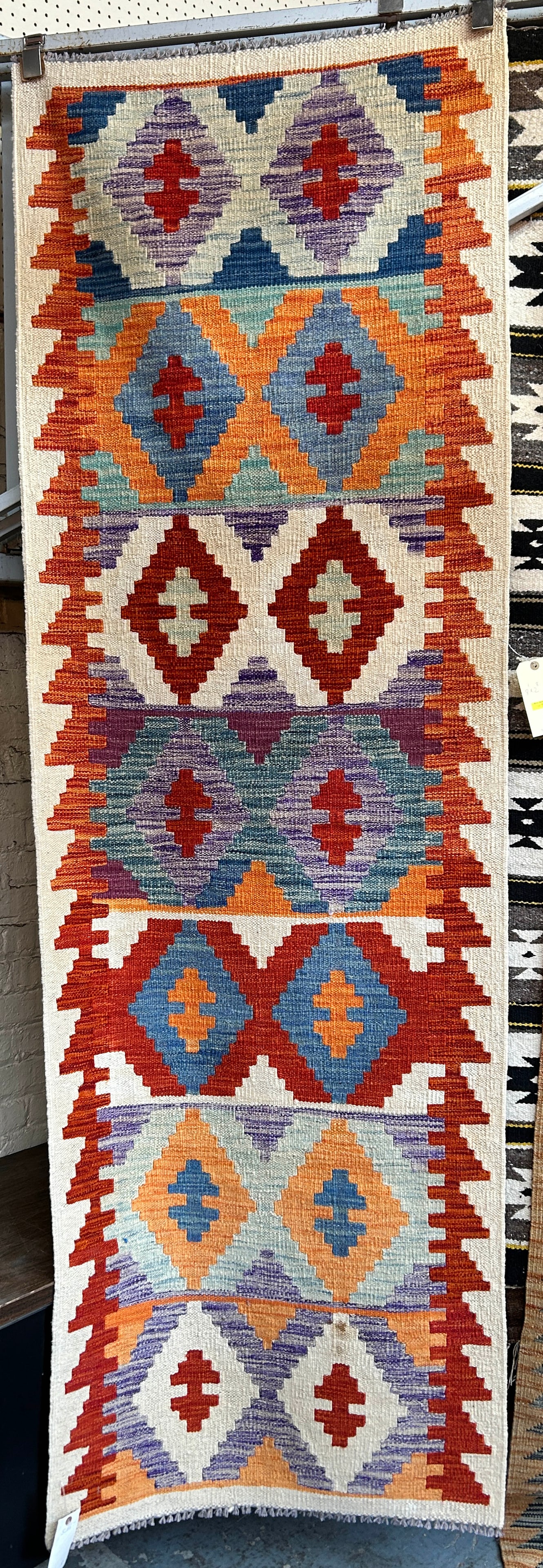 2' 8" x 8' 1" Colorful Kelim Runner Rug: This rug has rich colors, and would likely fit well with any decor. It is in good condition. In-House Shipping is available for this rug. Please see our website for our in-house shipping procedures.