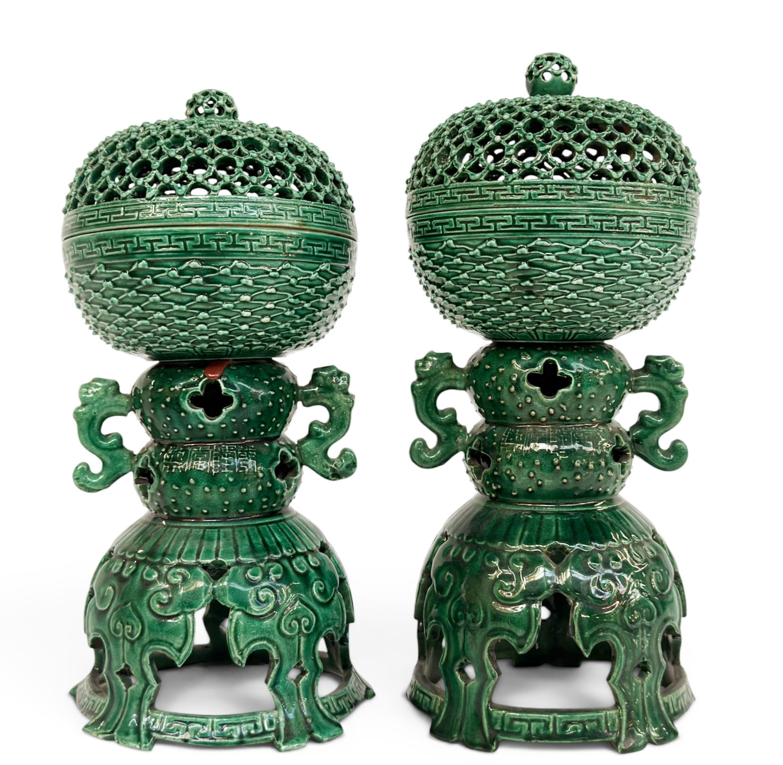 Pair of Chinese Green Glaze Porcelain Censers.: The openwork lidded censers look to be in good overall condition. Each piece has an export wax seal on the underside of the lid. Each piece, including the stand, measures 12" tall and 5" in diameter. 