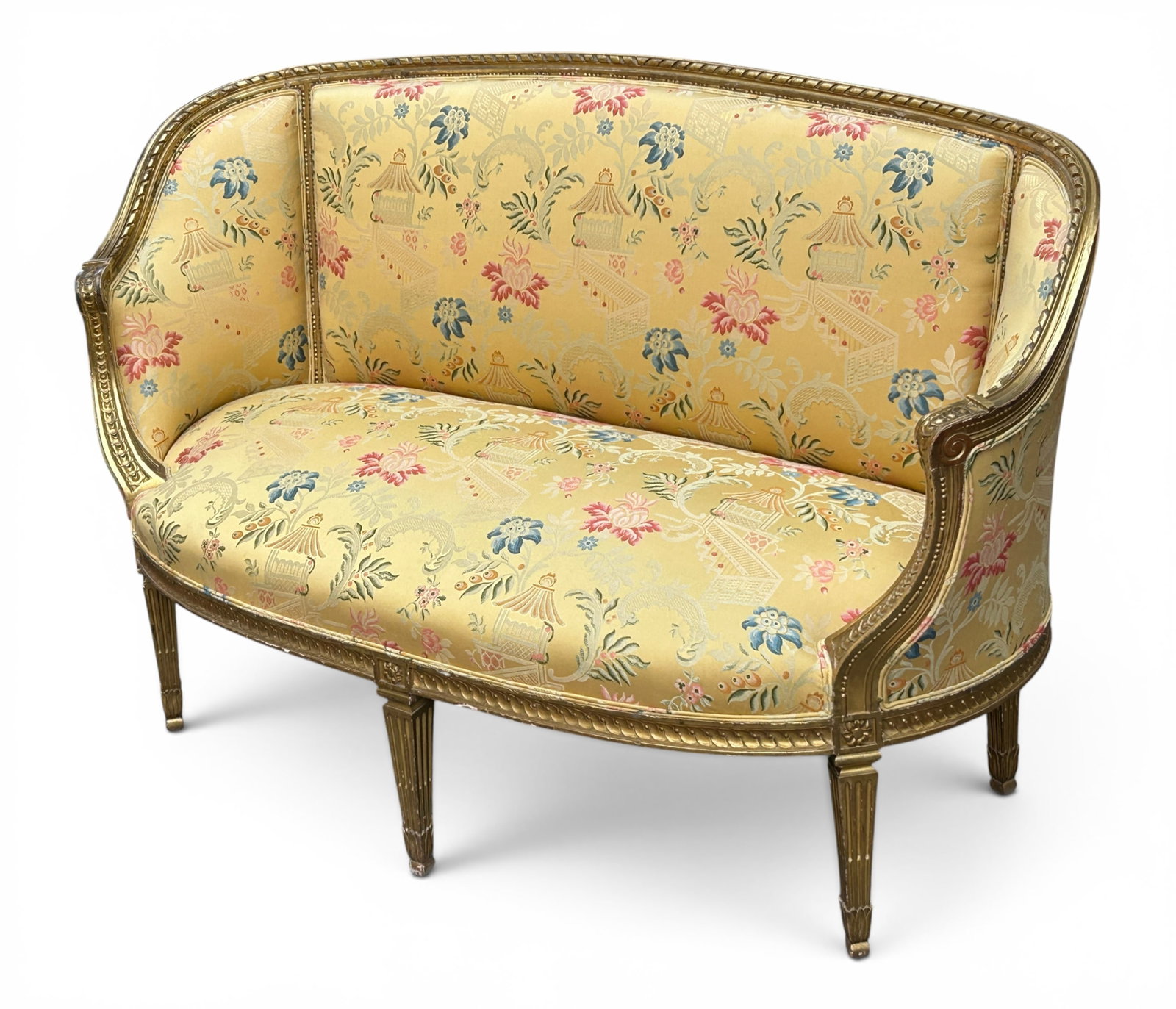 French Carved Giltwood Settee or Love Seat.: This piece has a giltwood frame, carved legs, and floral upholstery. There is some paint loss on the frame, as well as scratches and indentations. The frame has some separations of the wood. The sette