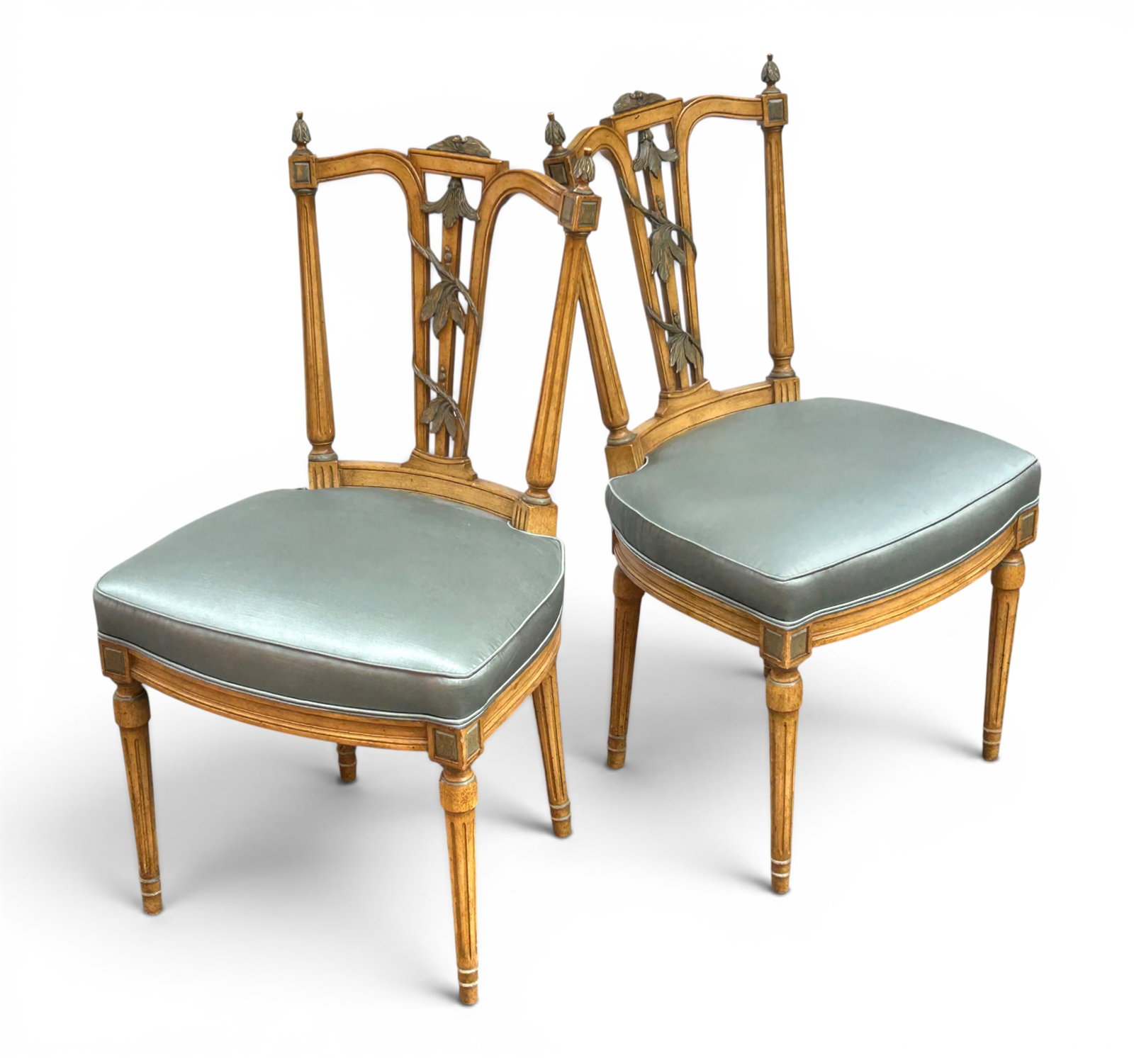Pair of French Carved Side Chairs.: These Louis XVI style side or accent chairs have carvings, fluted legs, and silk-like upholstery. There are some dirt marks on the fabric, as well as some minor scratches. Overall, they are in good