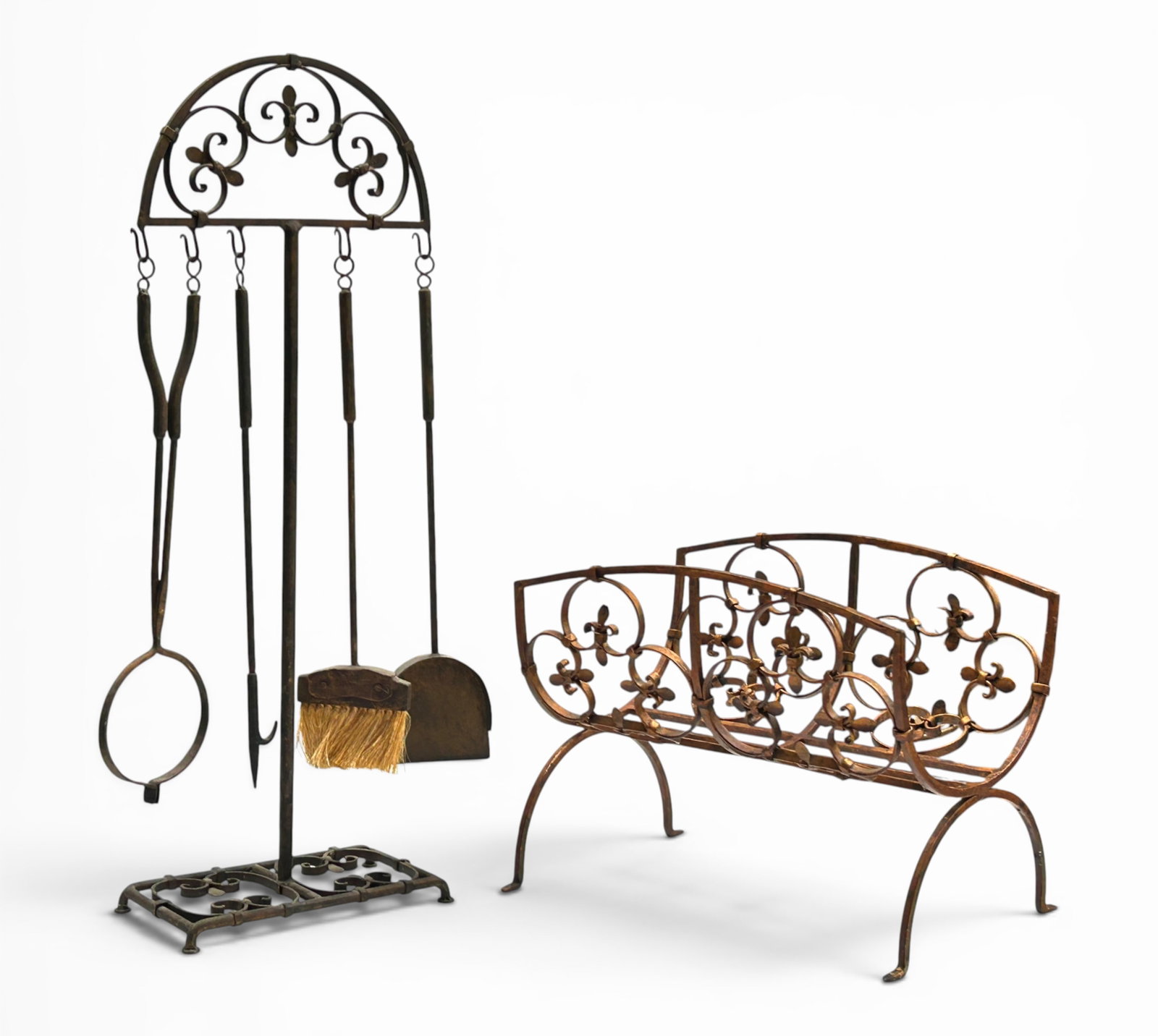 Metal Fireplace Tool Set & Log Holder.: The lot consists of a tool set on an ornate metal log holder stand. The log holder is constructed of wrought iron, and has an ornate floral design. There is some rusting and a few scratches. The tool
