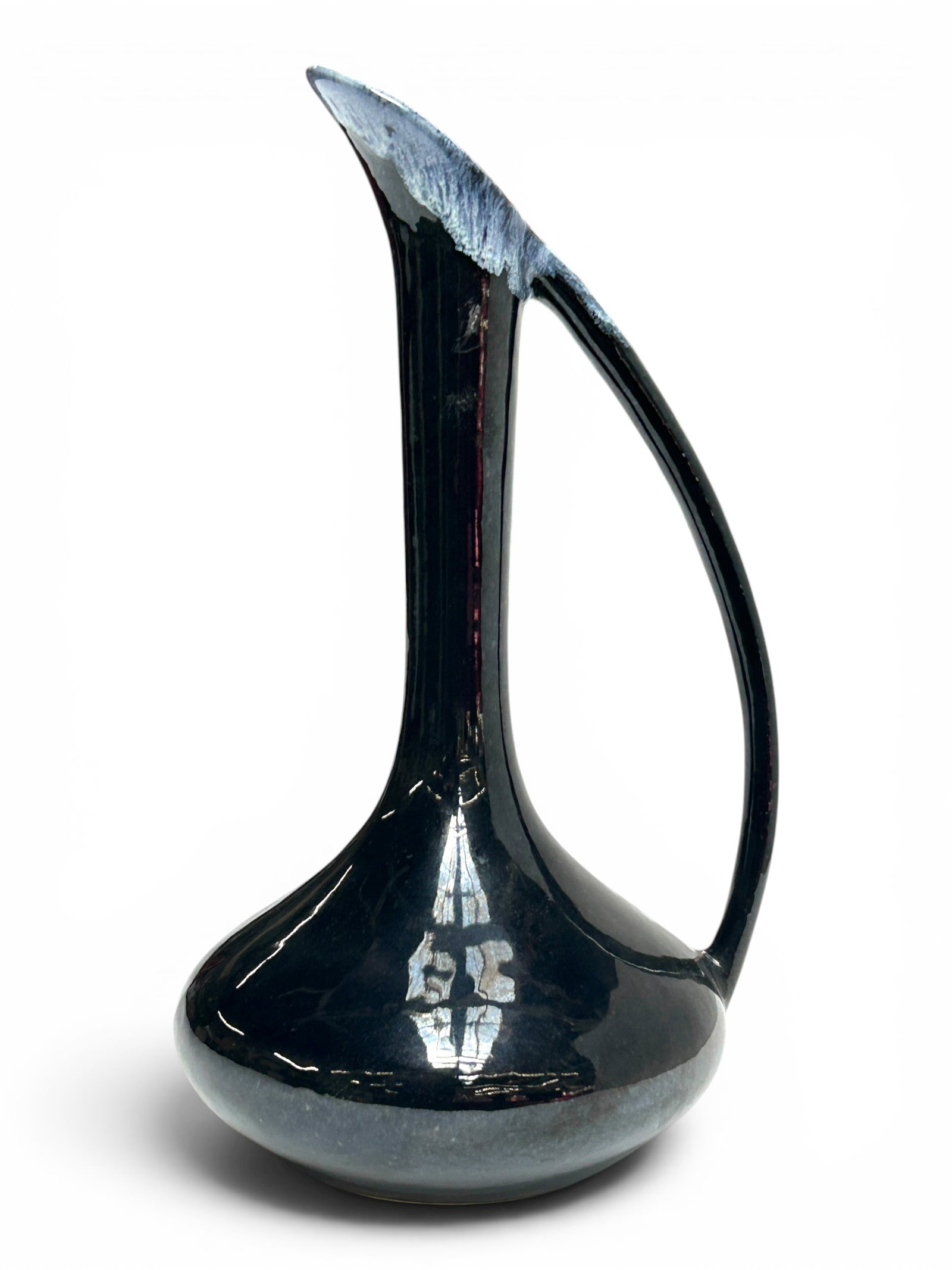 Van Briggle Ewer Vase, Dark Glaze.: The ewer vase is glazed in a dark color with a flowing gray/blue rim. It is signed Van Briggle Colo. Spgs. Co. ABL on the underside. It measures 11 1/2" tall, 6 1/2" wide, and 5 1/2" deep. The piece w