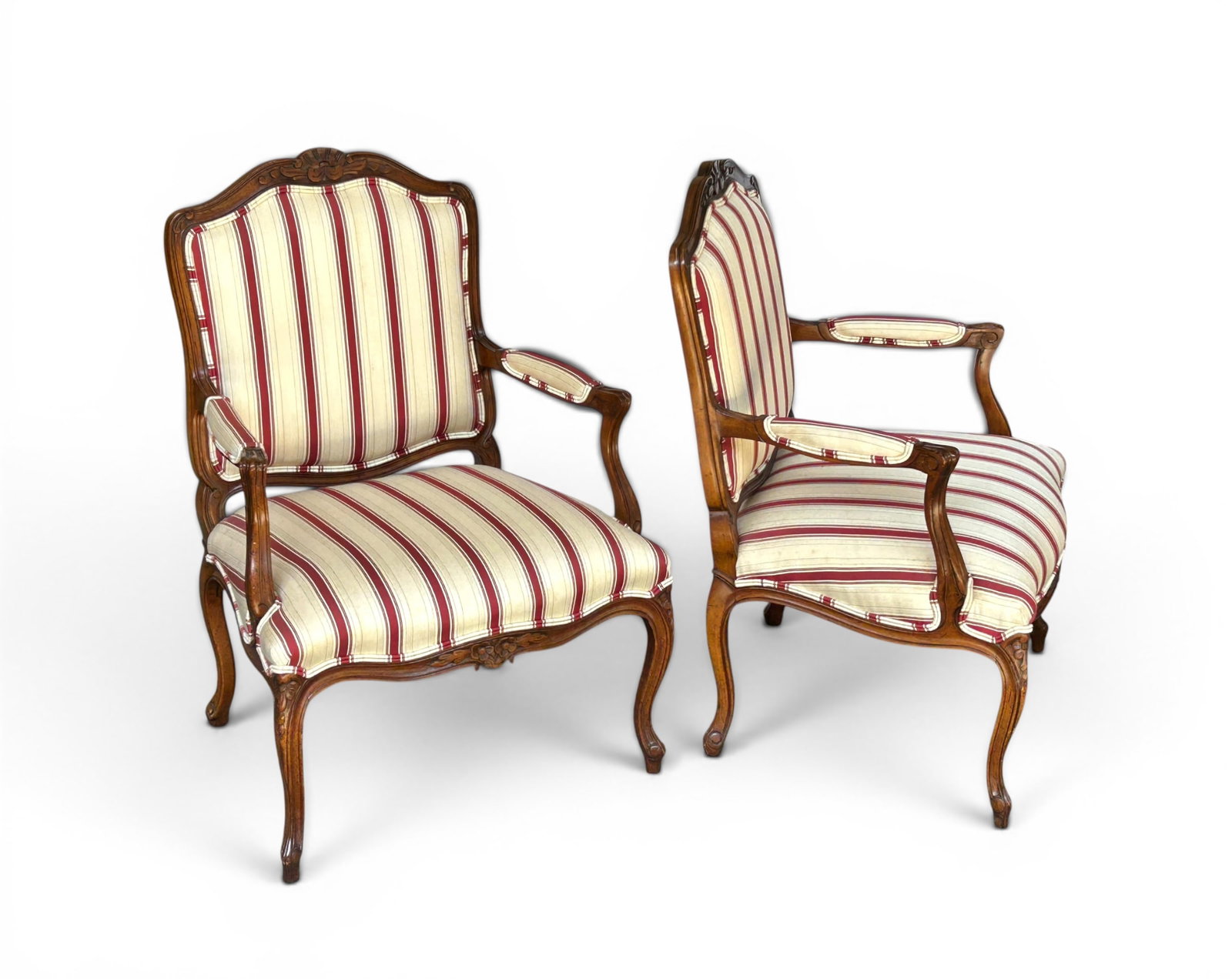 Pair of Louis XV Style Armchairs - Schoonbeck.: The chairs have carved frames and striped upholstery. The seat cushions are a little dirty, but otherwise, the chairs are in good condition. They each measure 27" wide, 21" deep, and 37" tall. Third-p