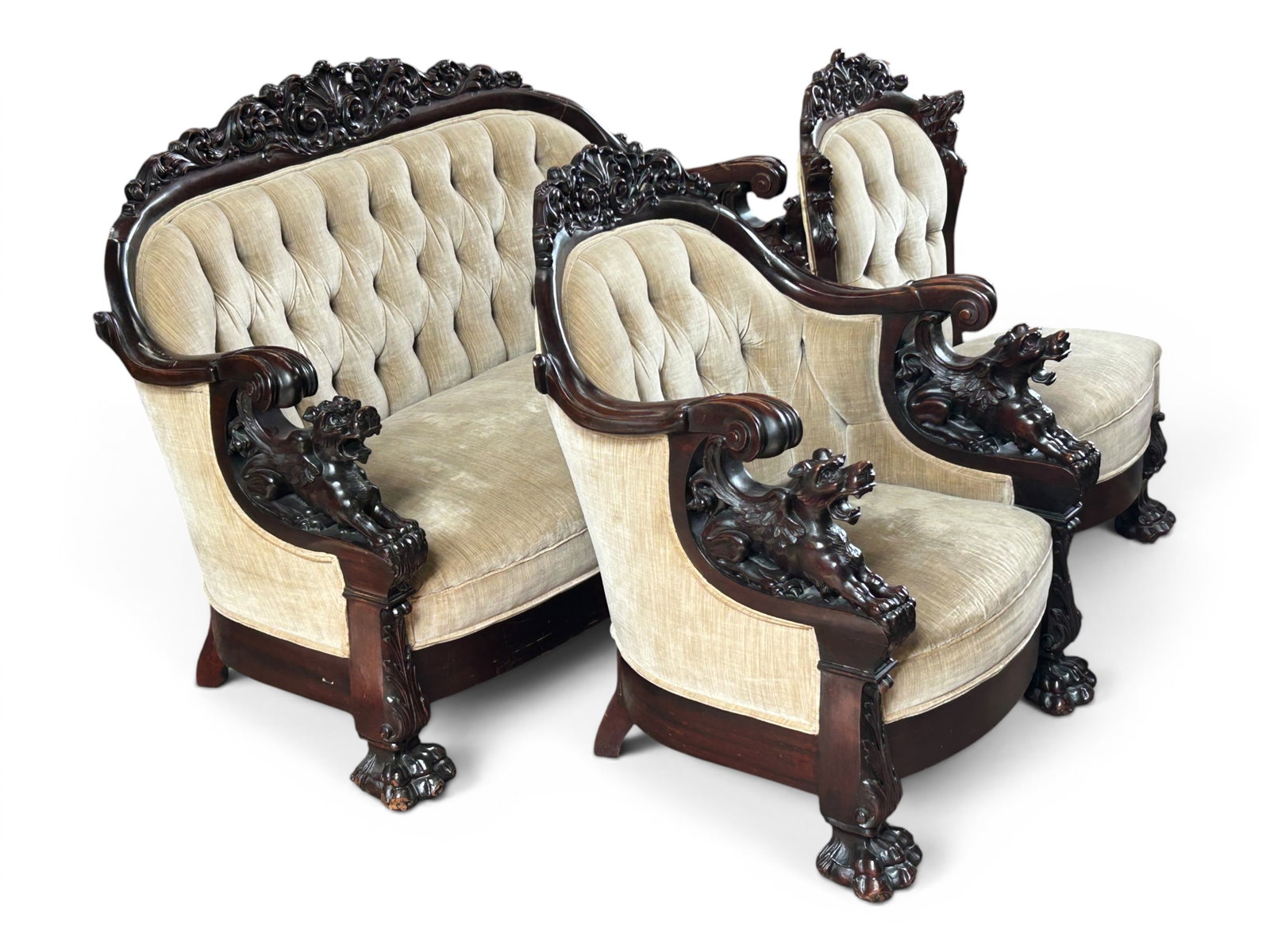 Victorian Carved Mahogany Living Room Set, Griffon: The set consists of a settee or sofa, an armchair, and a chair. The armchair and sofa have impressive winged griffin figures under the scrolled arms, and the chair has a couple of griffin heads on