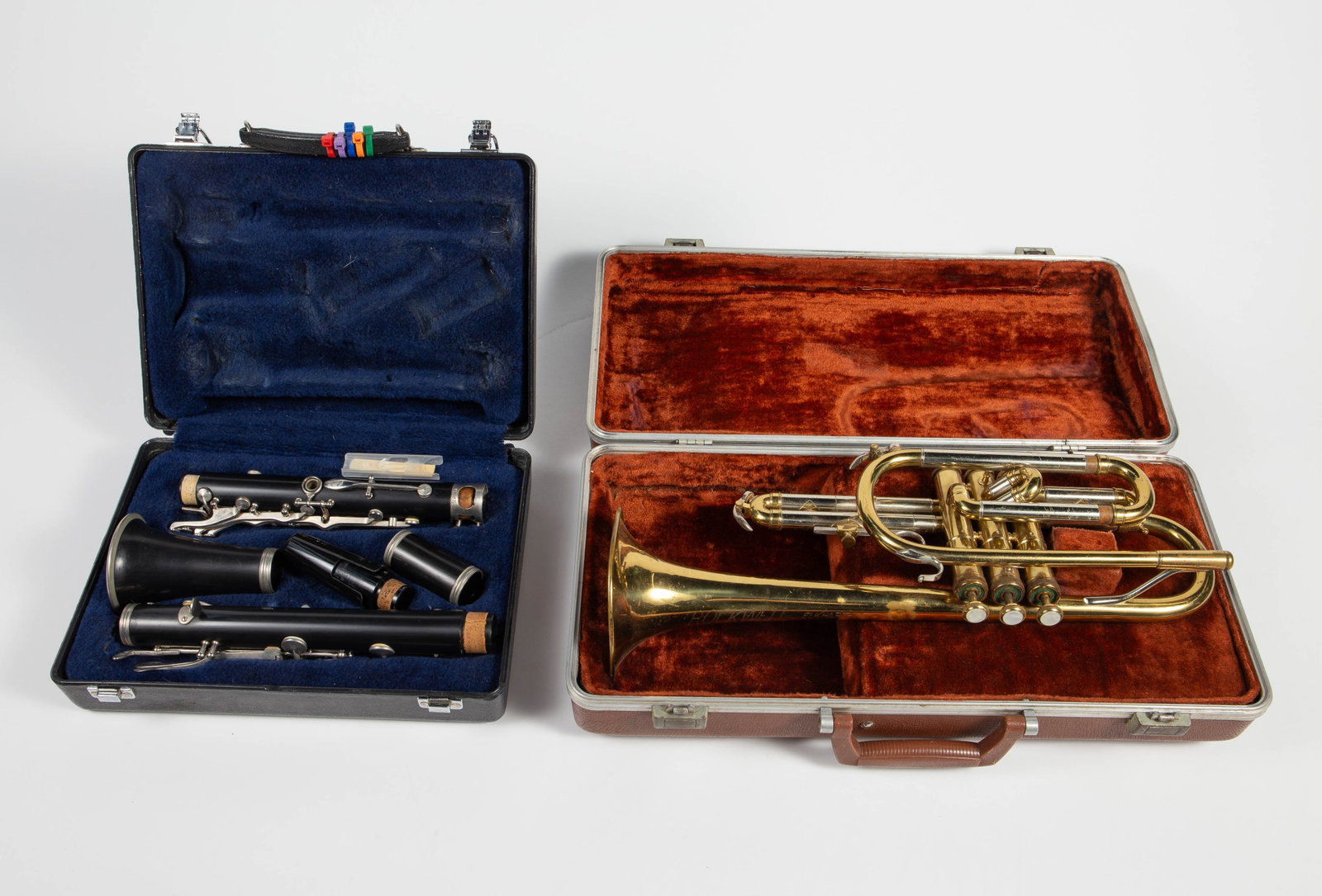 Lot: Vintage Cornet & Clarinet w/ Hard Cases.: They are untested. The cornet reads, "Rockwell Elkhart, Ind." with a serial number of 147707. It has some scratches and dents. The measurements are 17 7/8" x 7 1/4" x 4 5/8". The clarinet has a
