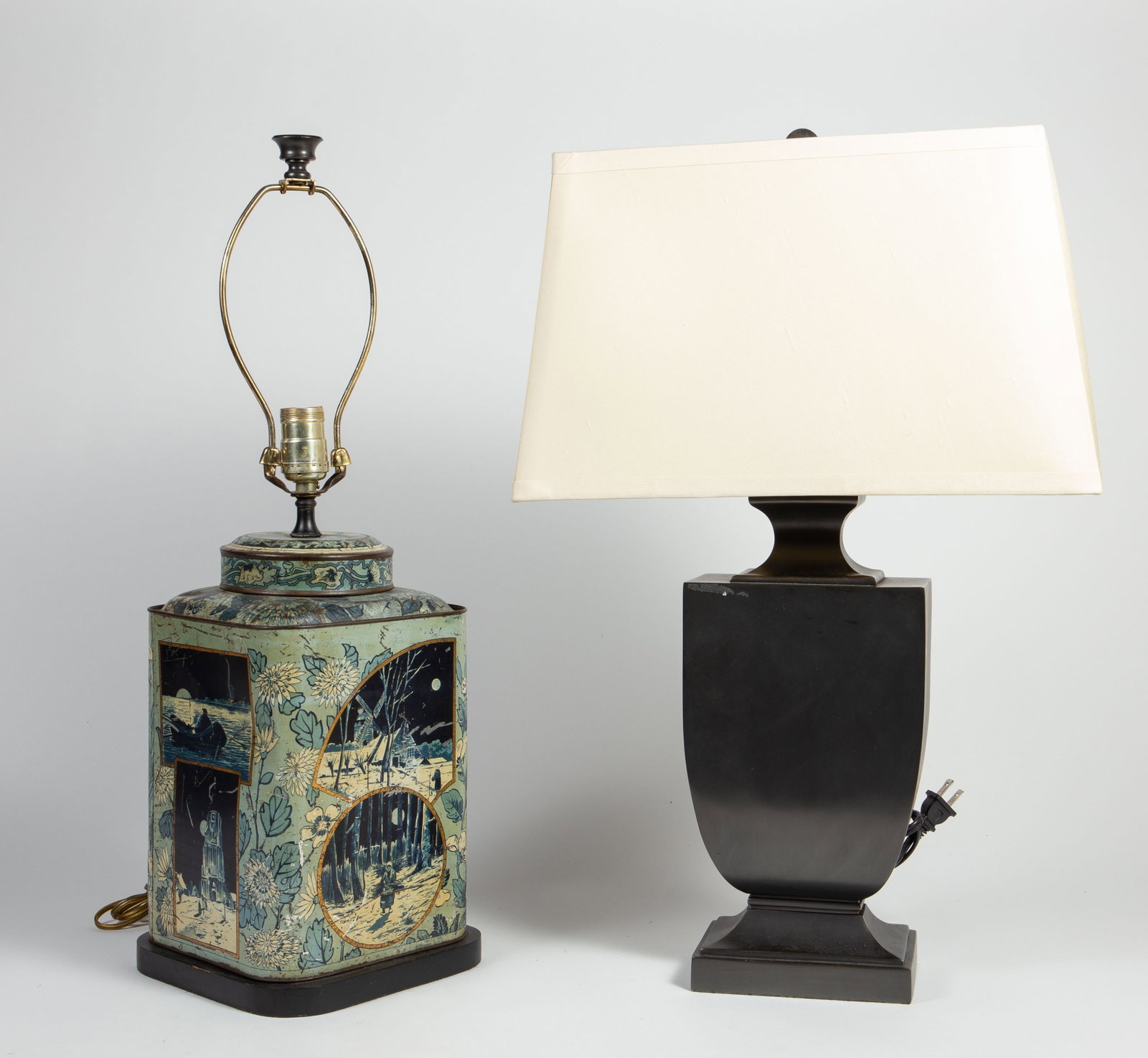 Lot of 2 Table Lamps- Restoration Hardware, etc.: This lot consists of two table lamps: one is a vintage tea canister lamp with Dutch scenes (7 3/8" x 7 3/8" x 24 3/8"), the other is a black Restoration Hardware lamp (6 3/4" x 4 1/4" x 24", with a sh